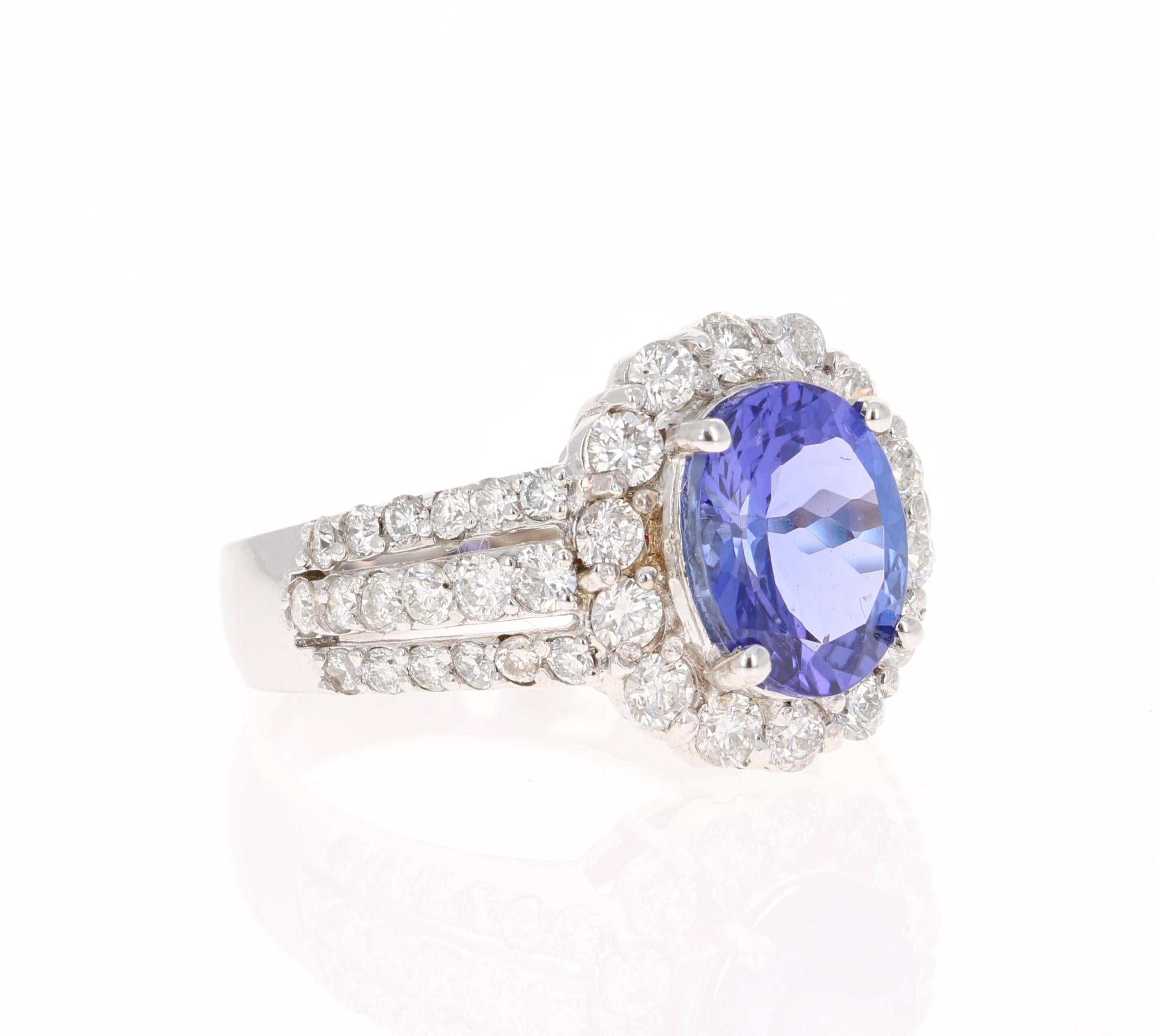 This beautiful ring has a vivid 2.74 Carat Oval Cut Tanzanite. The Tanzanite is surrounded by 50 Round Cut Diamonds that weigh 2.74 Carats. (Clarity: SI, Color: F)  The total carat weight of the ring is 5.48 Carats.  

The ring is made in 18K White