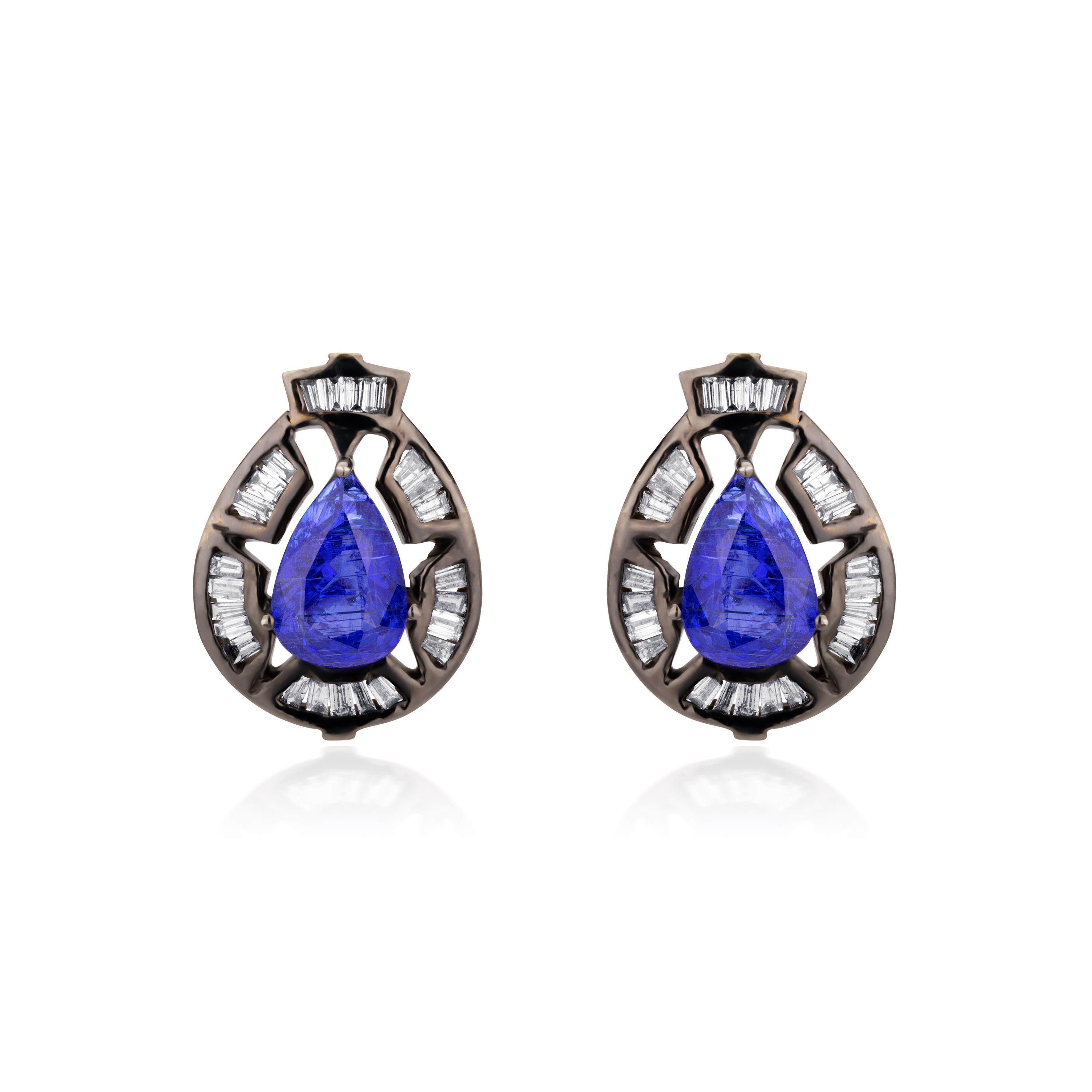 In these stunning Victorian era inspired studs, pear faceted Tanzanite, weighing 4.31Cts fill the glittering pierced frames of baguette diamonds (IJ Color, SI Clarity). Presented in 18K gold and 925 sterling silver, they are accompanied with post