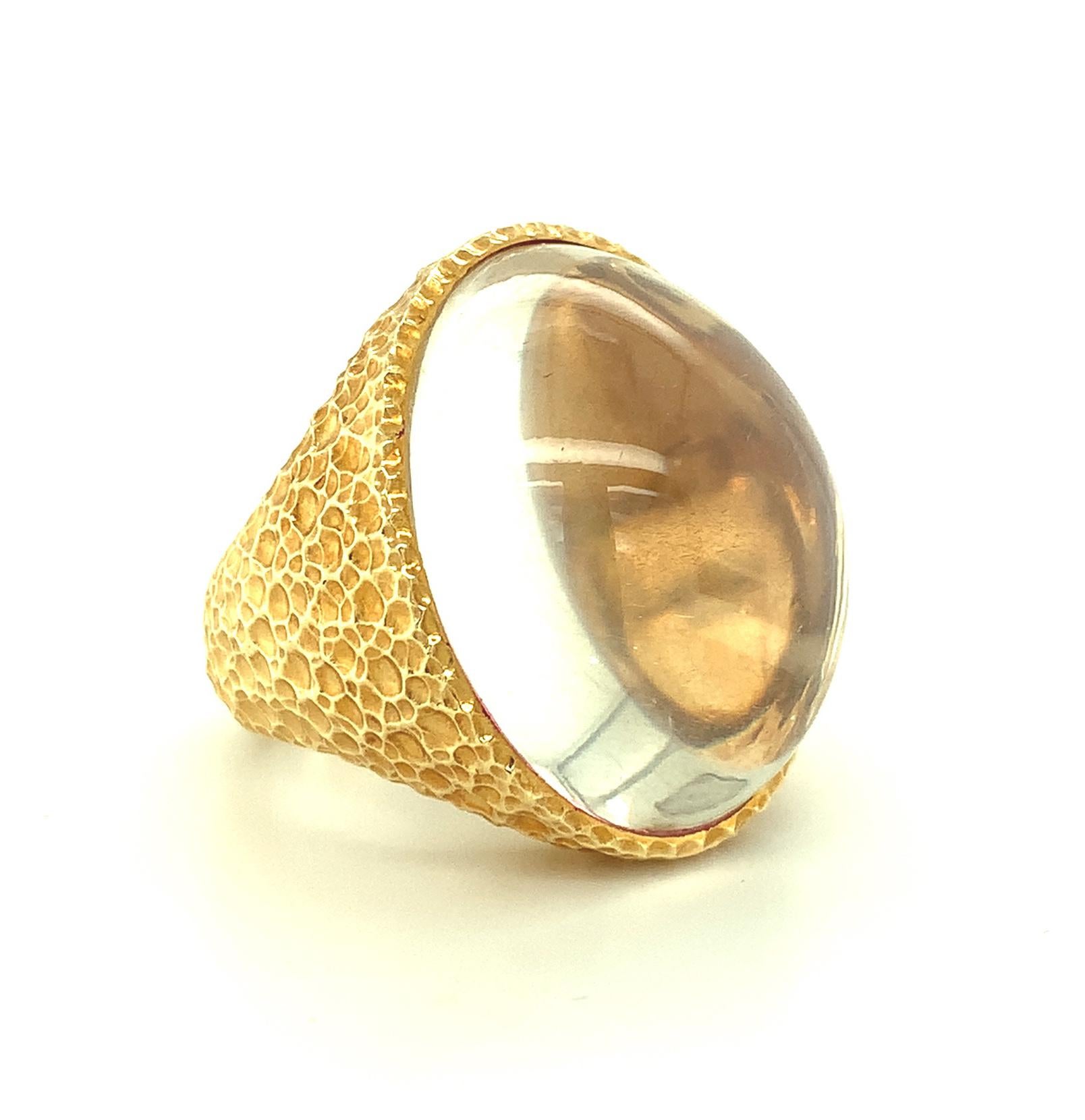 This ring features a giant oval moonstone cabochon weighing over 50 carats! It is unusual in that it is highly transparent but has delicate, sparkly 