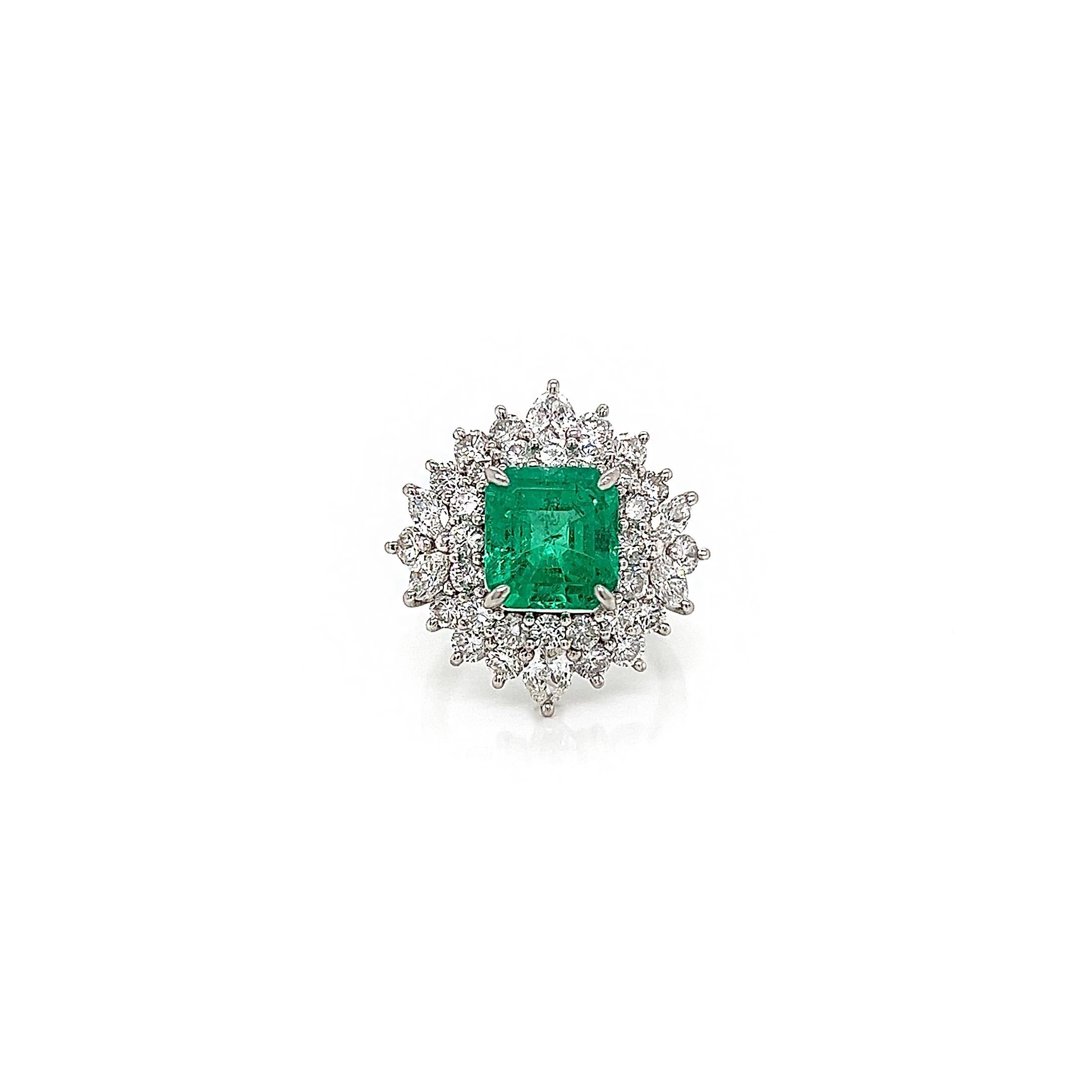 5.48 Total Carat Emerald and Diamond Halo Prong-Set Ladies Ring

-Metal Type: Platinum
-3.05 Carat Emerald Cut Natural Emerald
-Emerald Color: Green
-2.43 Carat Marquise, Pear and Round Natural side Diamonds. F-G Color, VS-SI Clarity

-Size