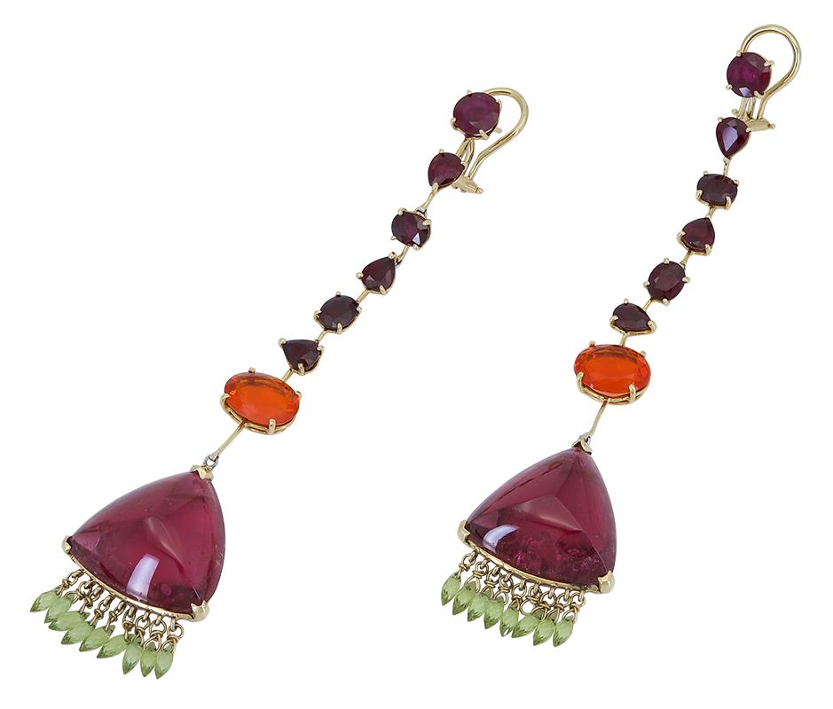 A beautiful pair of chandelier earrings showcasing two sugarloaf cabochon rubies suspended on a delicate row of vibrant fancy shape rubies. Finished with briole cut sapphires.
Sugarloaf rubies weigh 43.81 carats total.
Accent rubies weigh 11.16