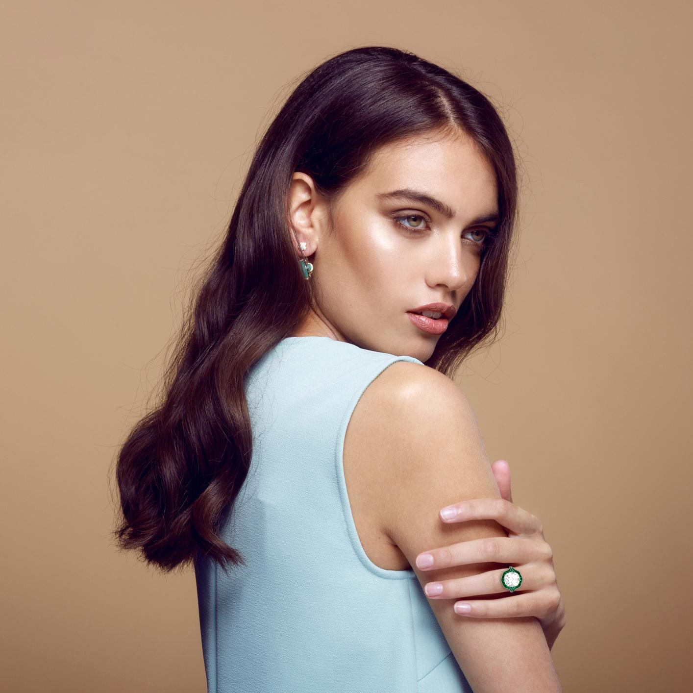 A striking example of vintage-inspired elegance, this impressive halo ring showcases a bezel-set antique cushion-cut diamond weighing approximately 5.40 carats. Graded K color and VS2 clarity, the center stone boasts a soft, romantic glow