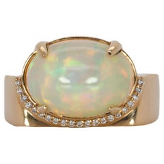 5.4cts, 14x10mm Fiery Opal Ring with Offset of Ethical Diamonds in 14K Gold