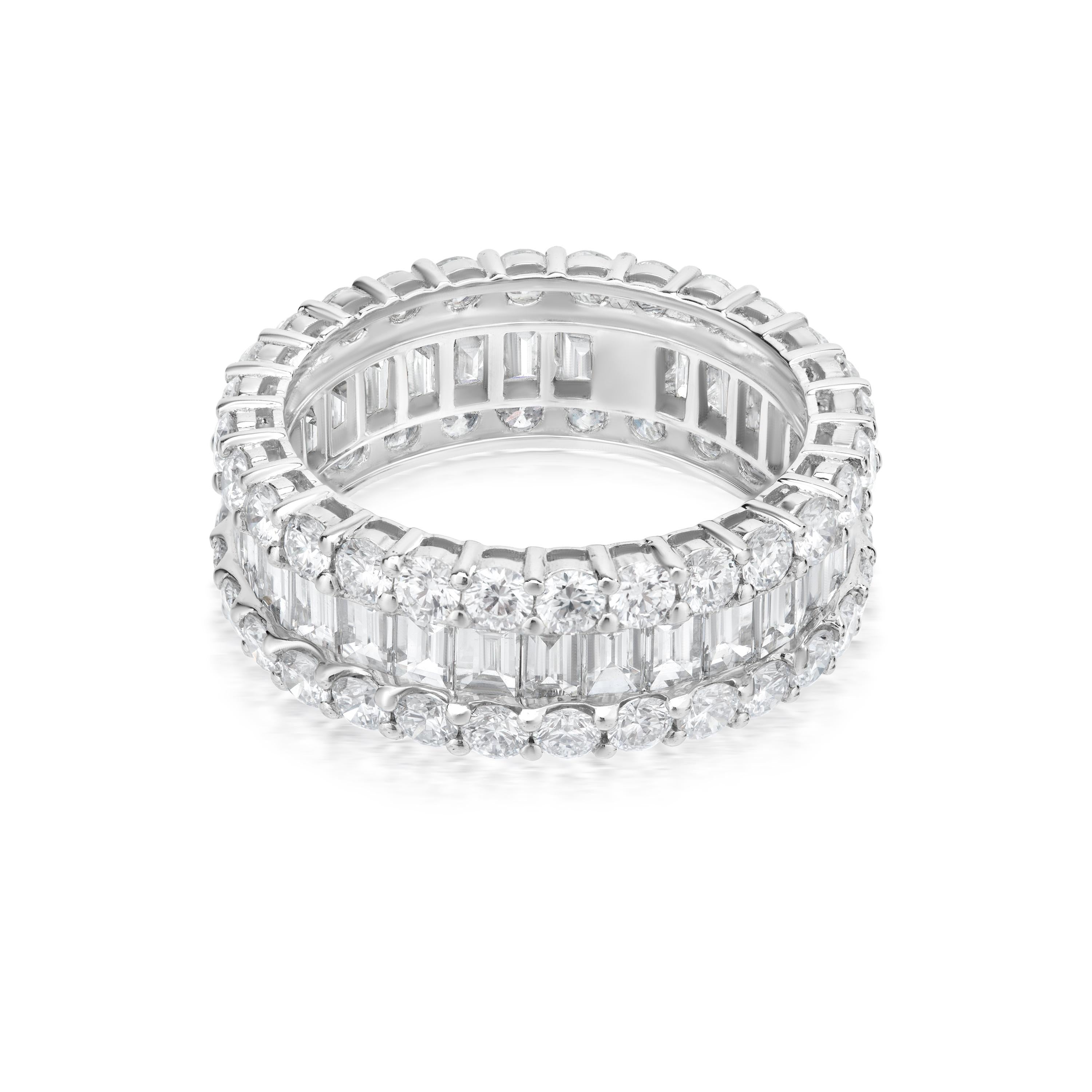Mounted on 18k White gold By Nigaam this diamond band ring features a channel of baguette diamonds set amidst twin circular rows of prong set round brilliant diamonds. The round full-cut diamonds are VS1 in clarity FG in color. This white gold band