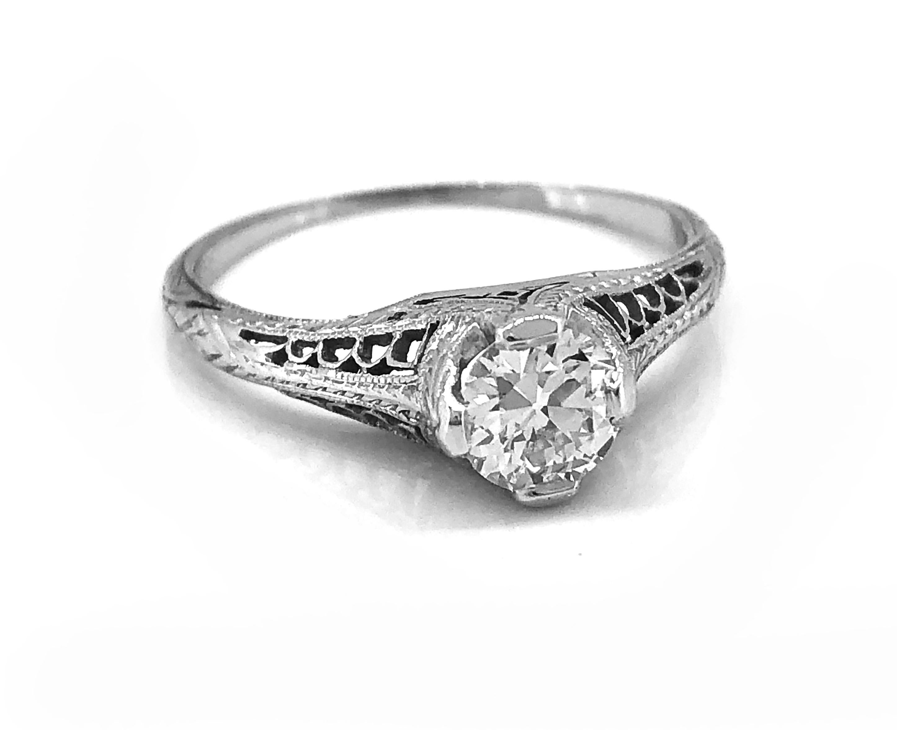 A beautifully pierced and engraved Art Deco Antique engagement ring that features .55ct. apx. Transitional cut diamond with SI1 clarity and H color. Crafted in platinum, this exceptional diamond engagement ring is sure to delight and turn