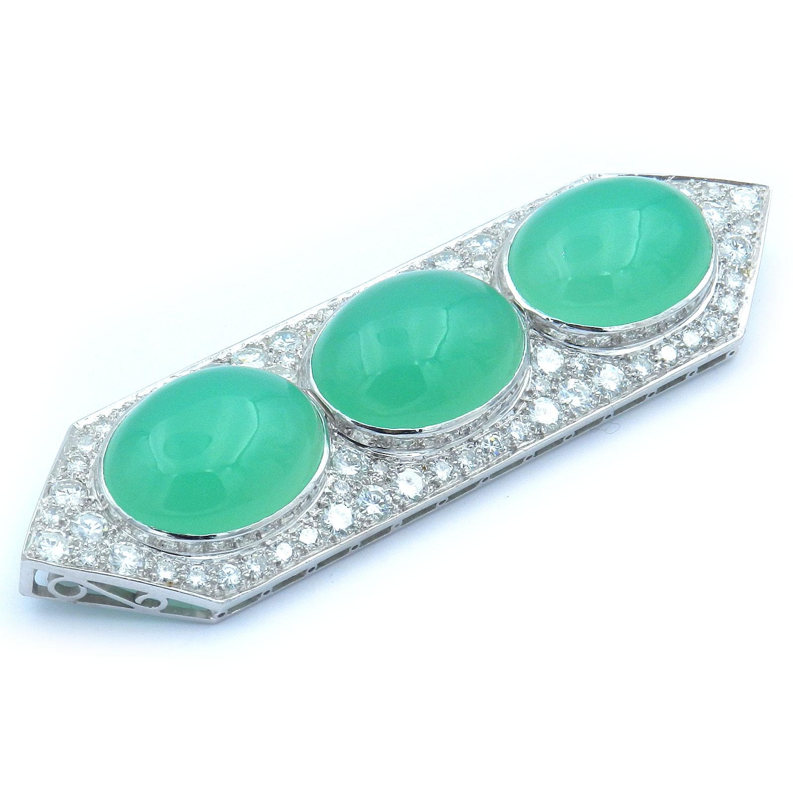 5.5 Carat Diamond Chrysoprase in 18K White Gold Brooch 

Magnificent diamond brooch made of 18-carat white gold in an elongated, geometric shape, centrally set with three luminous green chrysoprase cabochons and 74 radiant brilliant-cut diamonds