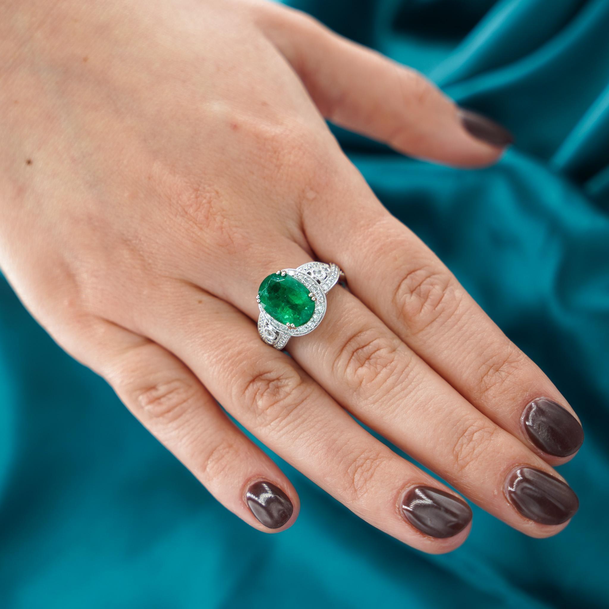 Natural 5.5 Carat Oval Cut Emerald & Diamond Pave 18K White Gold Vintage Art Nouveau Style Filigree Crossover Ring.

Details:
Item Type: Cocktail Ring
Metal: 18K White Gold 
Size: 7 3/4 (Adjustable)
Weight: 9.1 Grams

Center Stone Details:
Type: