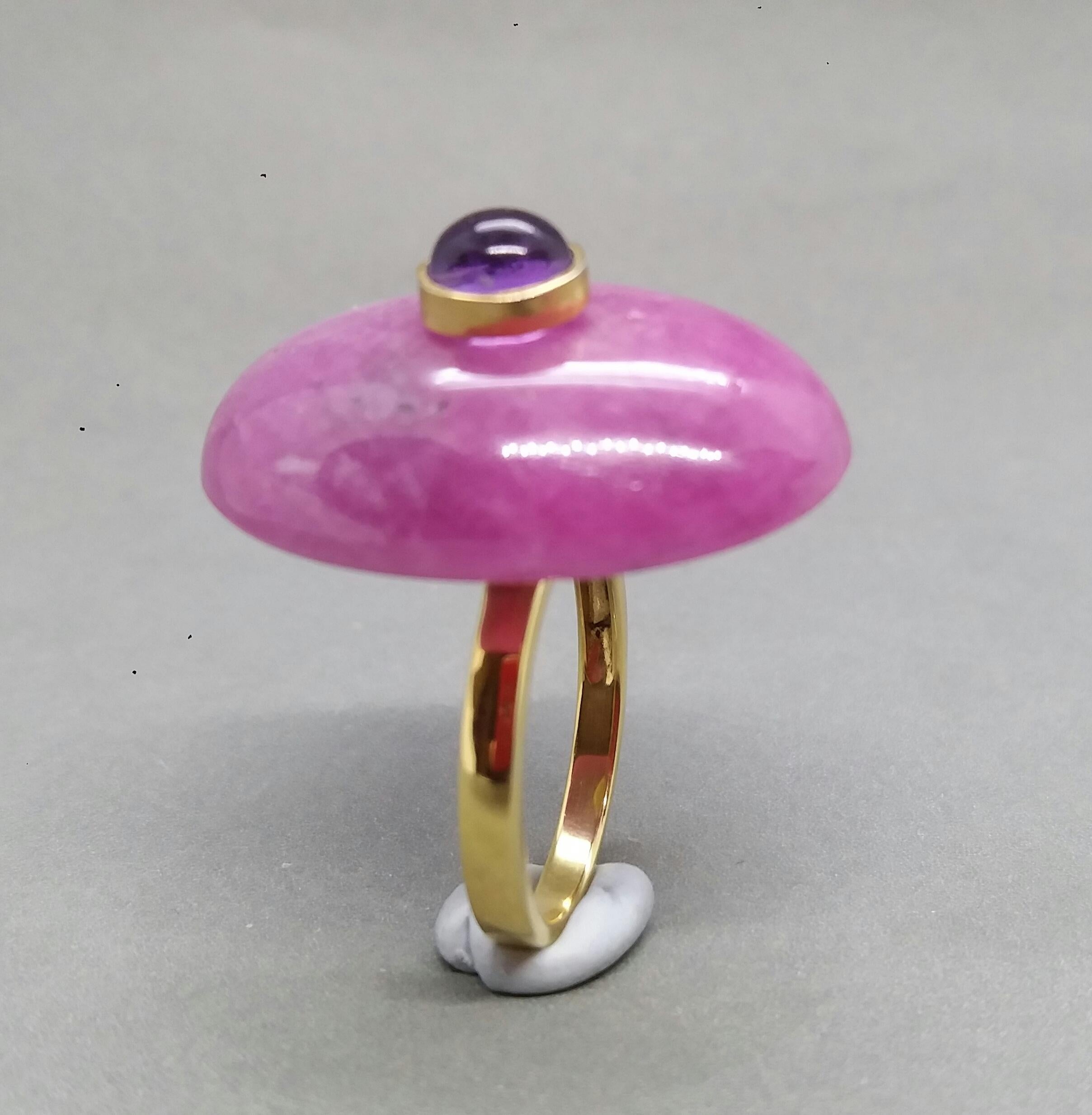 Unique ring with a Big Oval Shape Natural  Ruby,measuring 28 mm. x 20 mm x 6mm. and weighing 55 Carats with a Round Amethyst Cab measuring 6 mm in diameter set in 14 kt yellow gold bezel...Ring shank is also in 14 kt  solid yellow gold now in