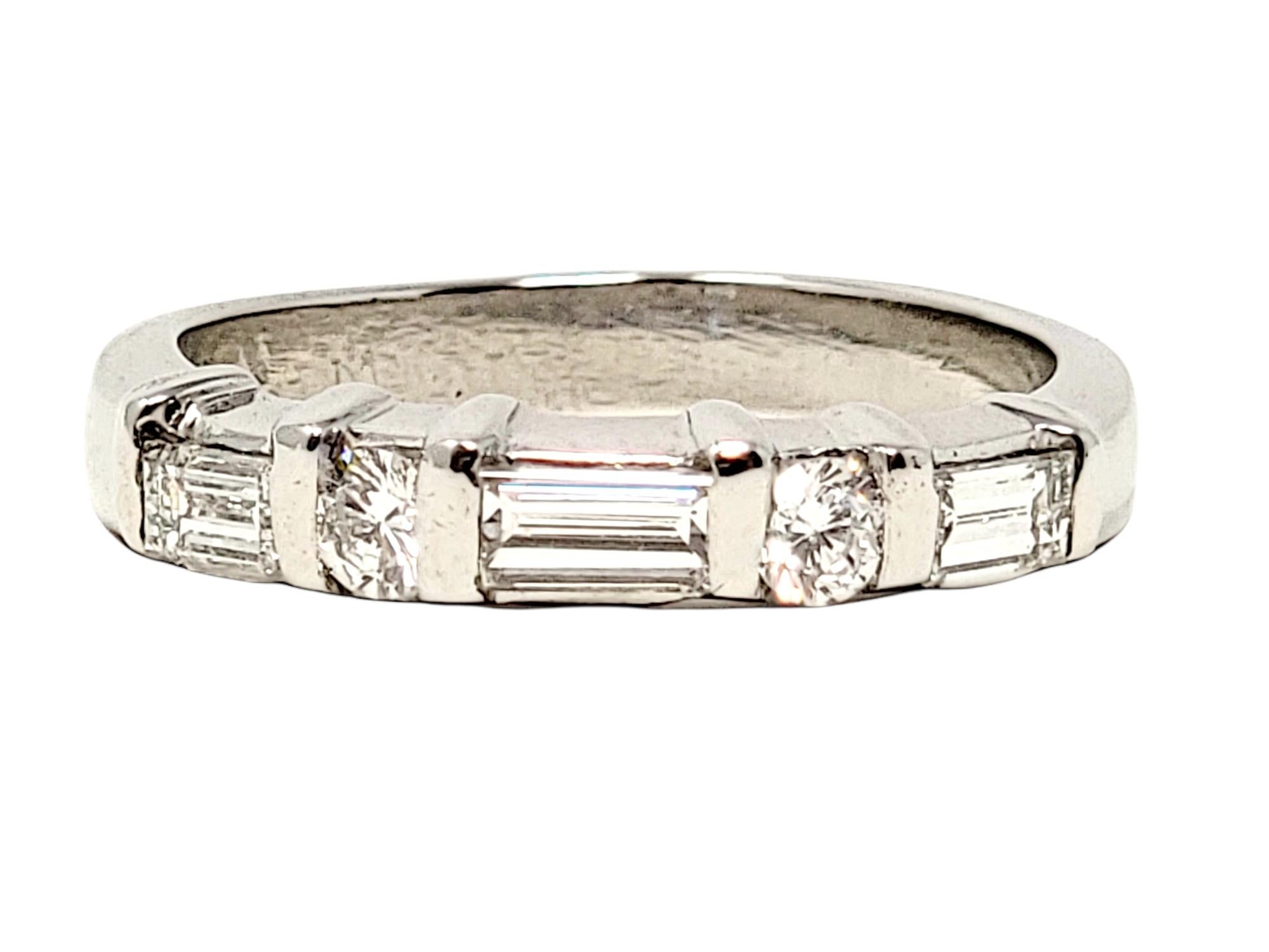 Ring size: 5.75

Stunning round and baguette diamond band ring. This sparkling beauty features icy white diamonds set in a single row, with the different shaped stones separated by polished platinum rows. Pair this versatile piece with your