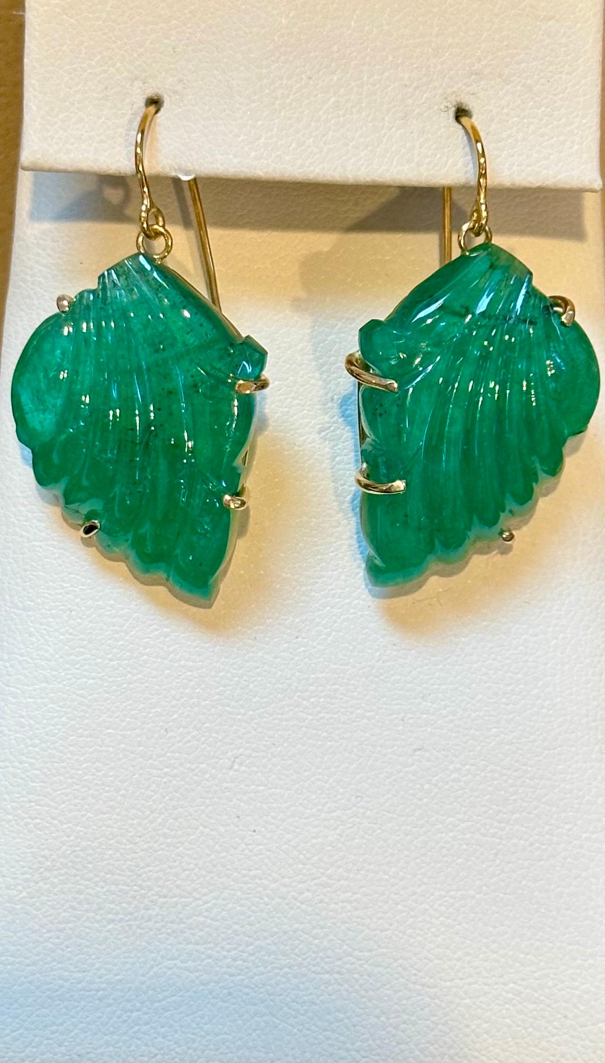 55 Ct Carved Emerald Leaf Shape Earrings 14 Kt Yellow Gold French Wire Earring
 Emerald    Post  Earrings  14 Karat  Yellow Gold wire
Two fine carved  leaf emeralds of total 55 ct  
Weight of 14 Karat gold with stone is 12.4 gm
This exquisite pair