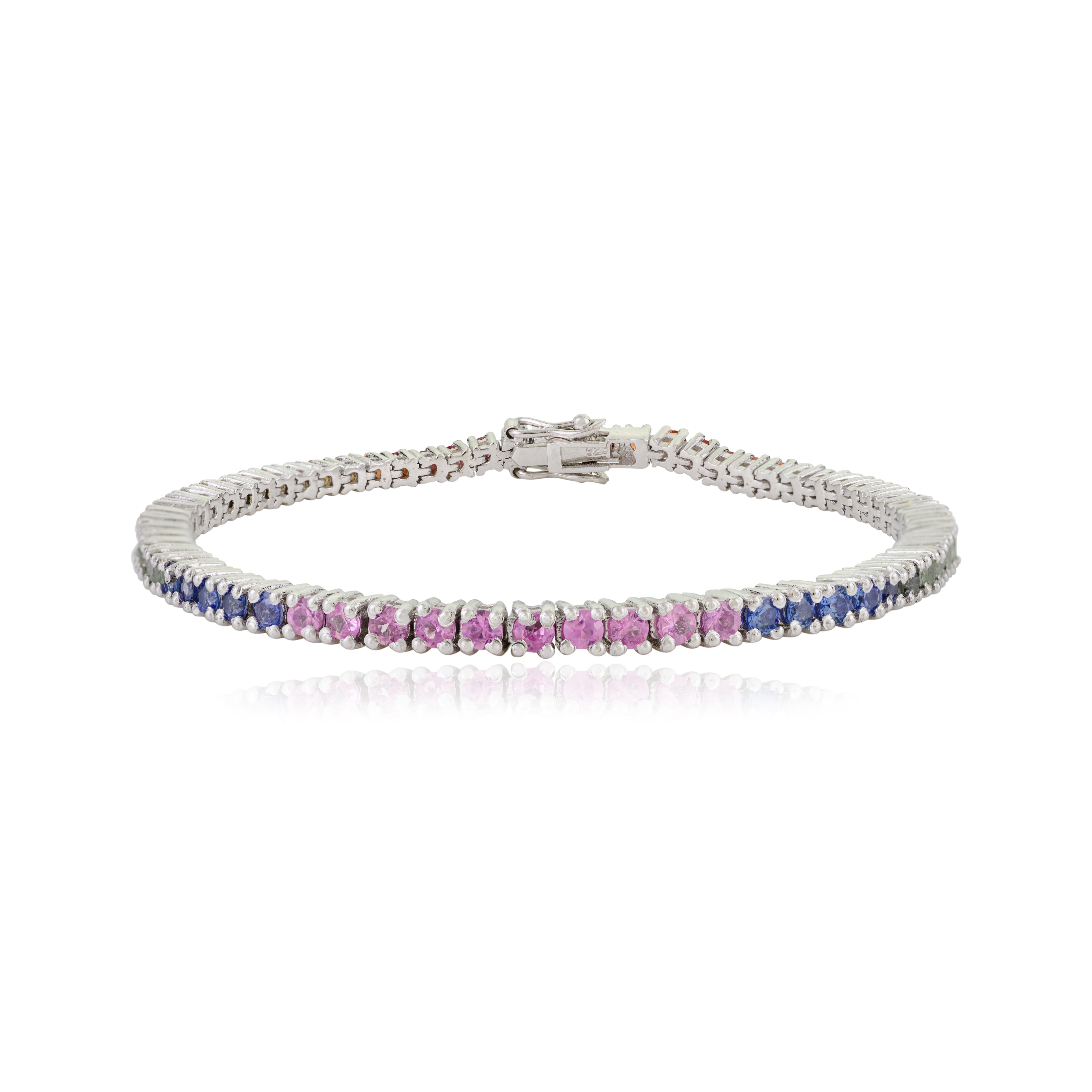 This high-quality, lightweight bracelet features 65 vivid natural multi-colored sapphires, each 2.5 mm in diameter, set in 925 sterling silver. The sapphires are prong-set to enhance their brilliance and creating a seamless balanced look with a