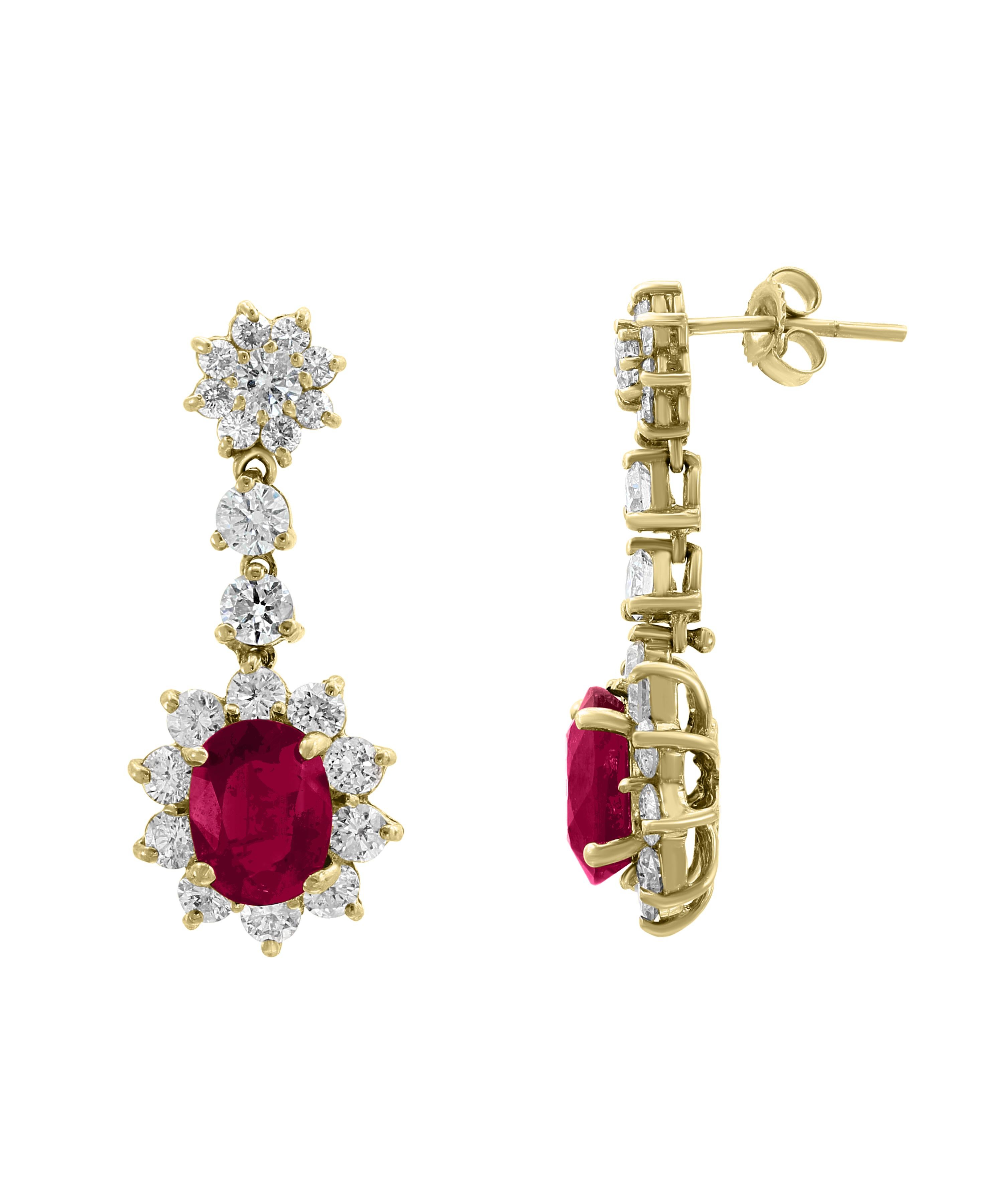 5.5 Carats  of two  Ruby   and  5 Ct Diamond  Hanging Earrings 18 K Yellow Gold
This exquisite pair of earrings are beautifully crafted with 18 karat Yellow gold  weighing    
 8.0  grams
 Ruby : 5.5 Ct
Ruby is treated.
Diamonds : approximately 5.0