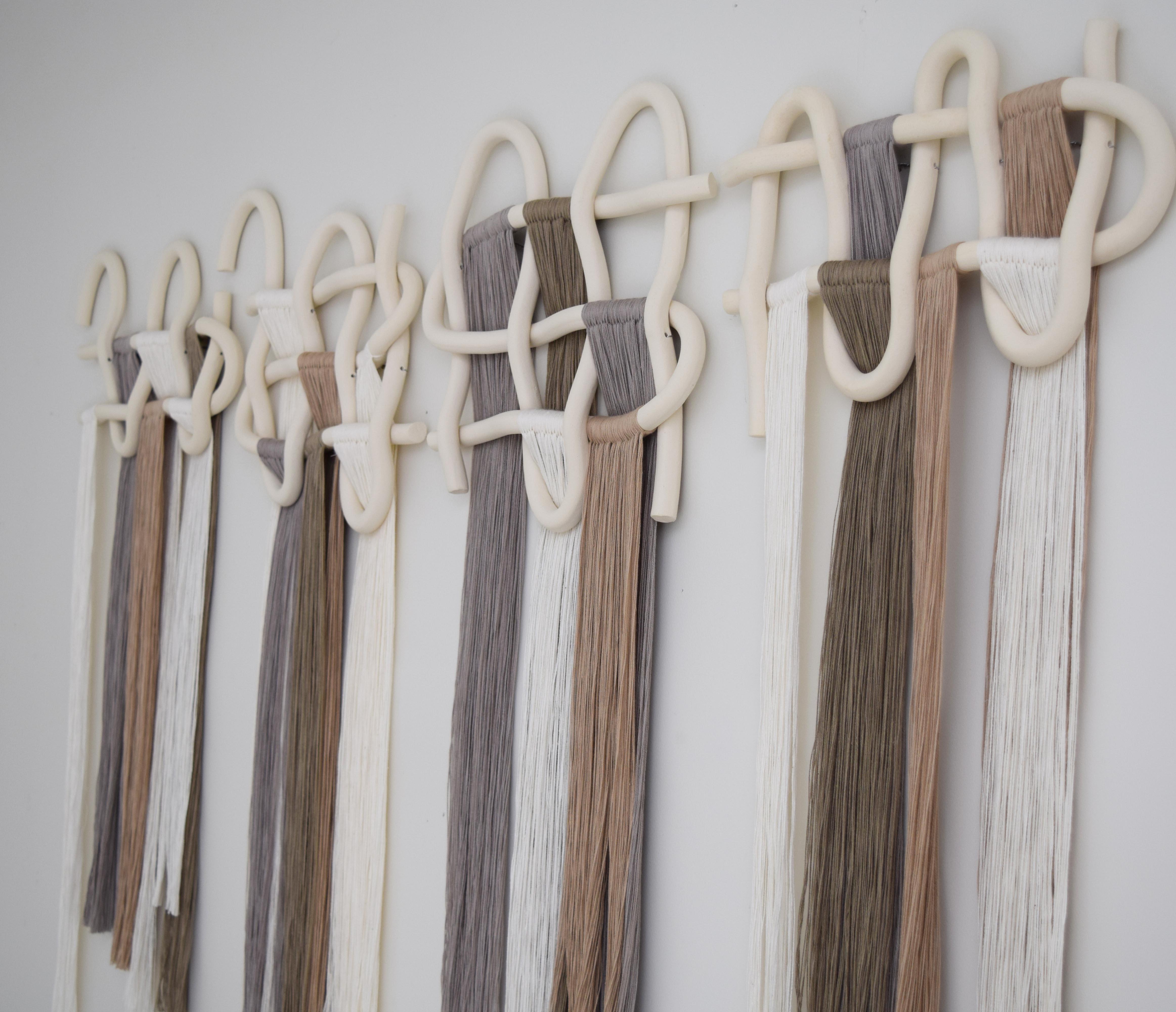 Wall Sculpture #758 by Karen Gayle Tinney

Four panel wall sculpture. Hand formed ceramic pieces in unglazed white stoneware with cotton fringe. Hanging wire is included on each panel. Ships with a small comb for fringe and installation