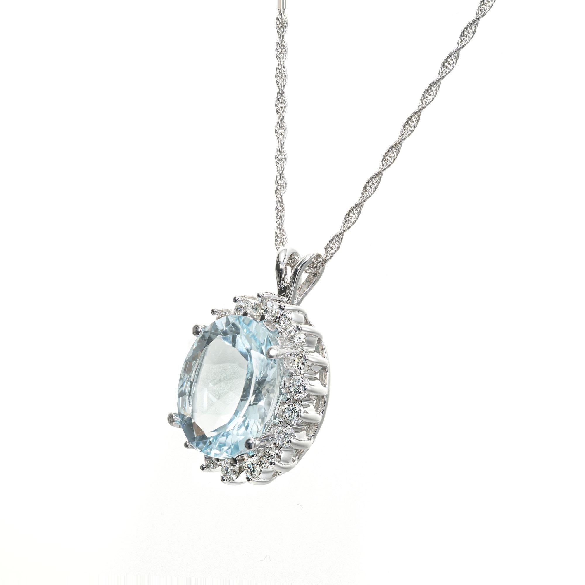 1960's Aqua and diamond halo pendant necklace. 5.50ct natural untreated oval aqua surrounded by 18 round brilliant cut accent diamonds in 14k white gold. 18 inch chain. 

1 oval cut blue aquamarine, VS approx. 5.50cts
18 round brilliant cut