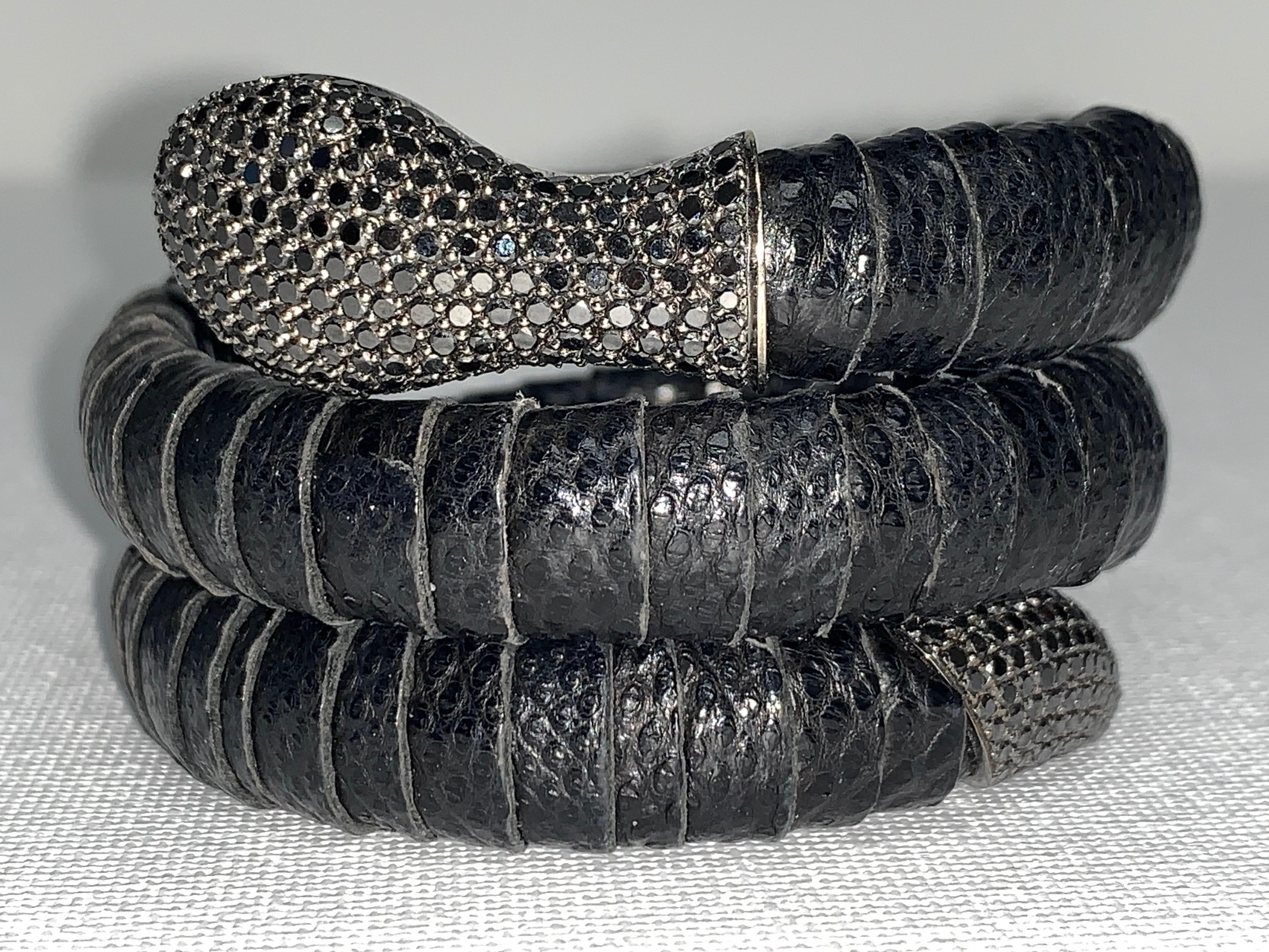 Black Pavé Diamond, Leather Snake Bracelet. 

Featuring a Black Pavé Diamond Snake Bracelet with a total weight of 5.50 carats, set in 18K White Gold. 

The body of the snake is made of fine genuine black leather.  The head and tail are accented