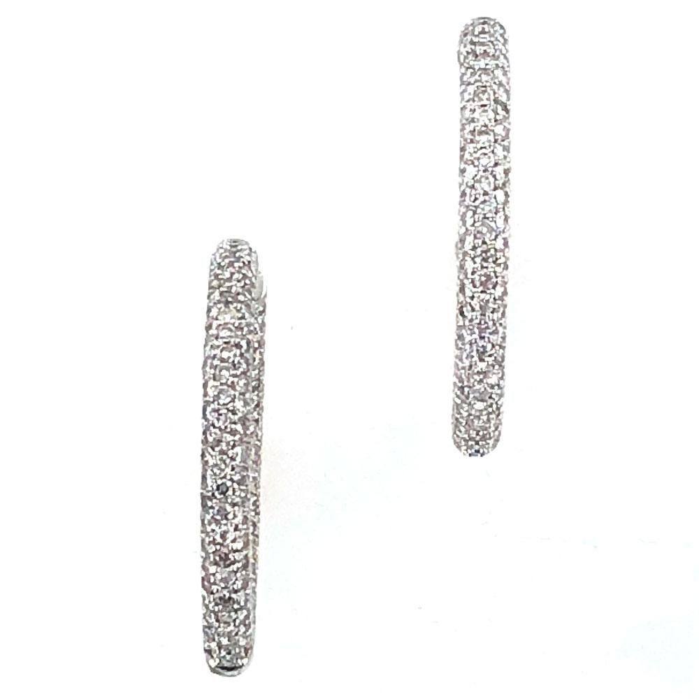 Stylish pave diamond hoops feature 5.50 carats of round brilliant cut diamonds. The diamonds are set in an in/out fashion so that you see brilliance from every angle. The hoops measure 1.4 inches in diameter, and 4mm in width. 