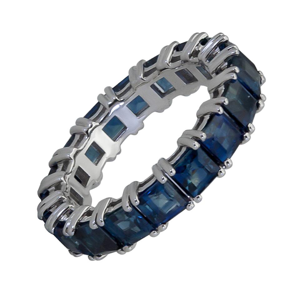A classic eternity wedding band style showcasing a row of emerald cut blue sapphires set in a chic 14k white gold mounting. 
Blue sapphires weigh 5.50 carats total.
Size 6.5 US.