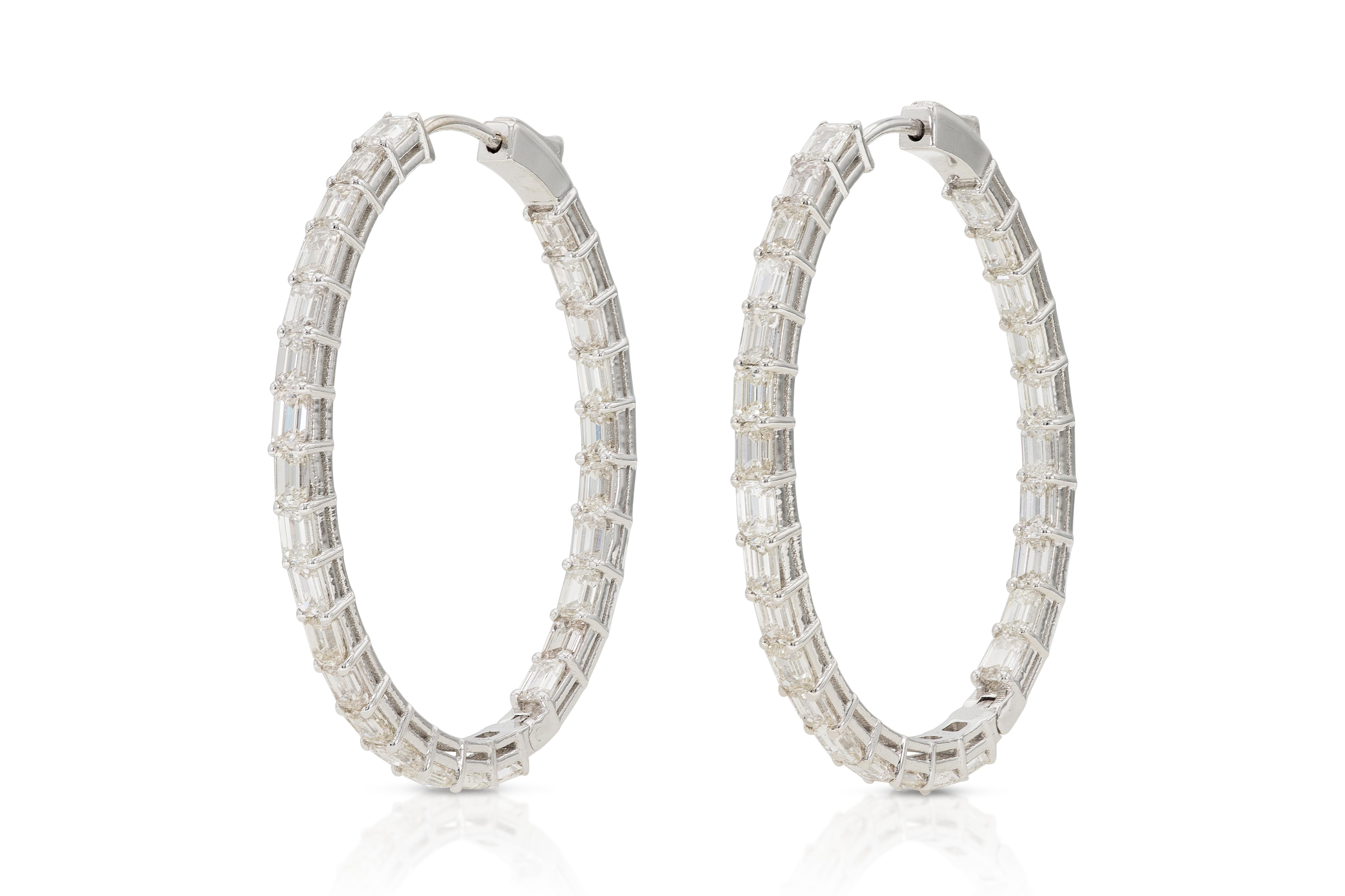 Finely crafted in 14k white gold with 54 Emerald cut Diamonds weighing approximately a total of 5.50 carats.
1 1/2 x 1 1/4 inch, 3 mm thickness