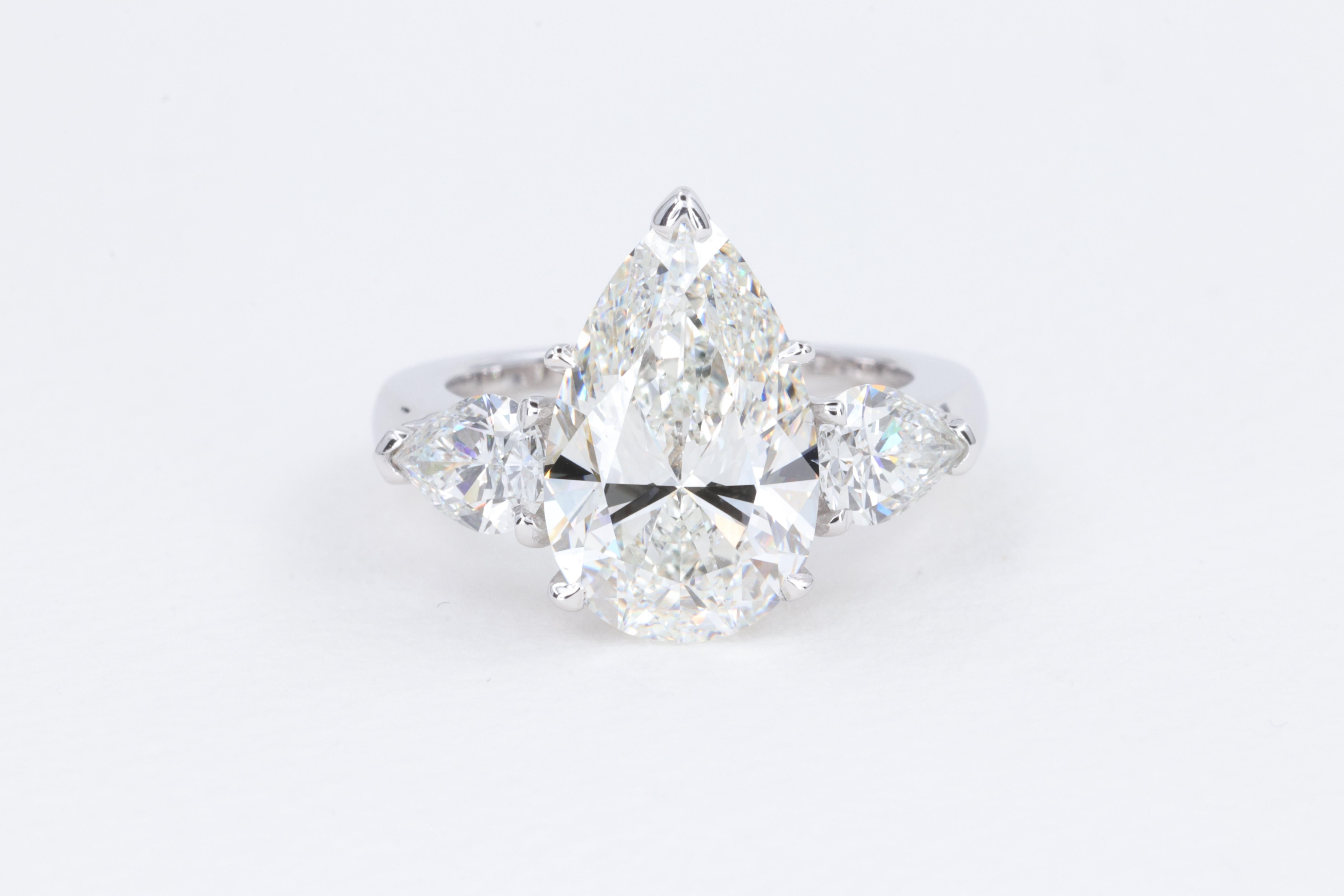 5.50 Carat GIA Natural Diamond Pear Shape Engagement Ring in 18 Karat White Gold

A perfectly done classic 3 stone diamond engagement ring set with a 4.50 carat H color SI1 clarity pear shape center diamond cut to a perfect model and proportions