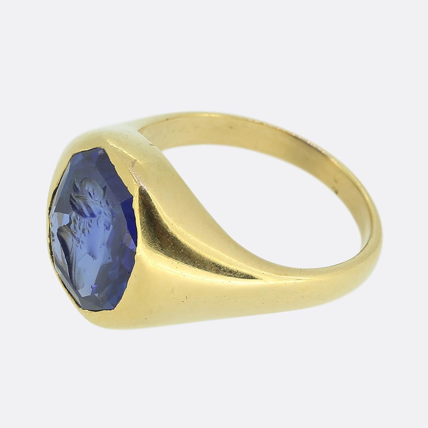 Here we have a striking signet ring featuring a sensational natural blue sapphire of Ceylon origin. This captivating stone has been expertly carved to showcase a highly detailed depiction of a Roman bust which sits harmoniously bezel set within a