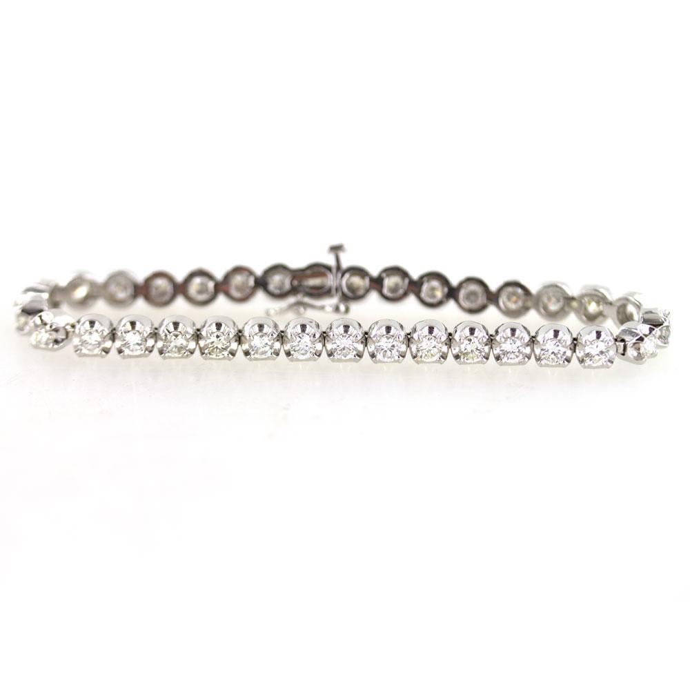 Diamond tennis bracelet featuring 33 round brilliant cut diamonds. The diamonds are all graded H-I color and SI1-2 clarity, and equal 5.50 carat total weight.  Fashioned in 14 karat white gold, the bracelet measures 7 inches in length and 5.5mm in