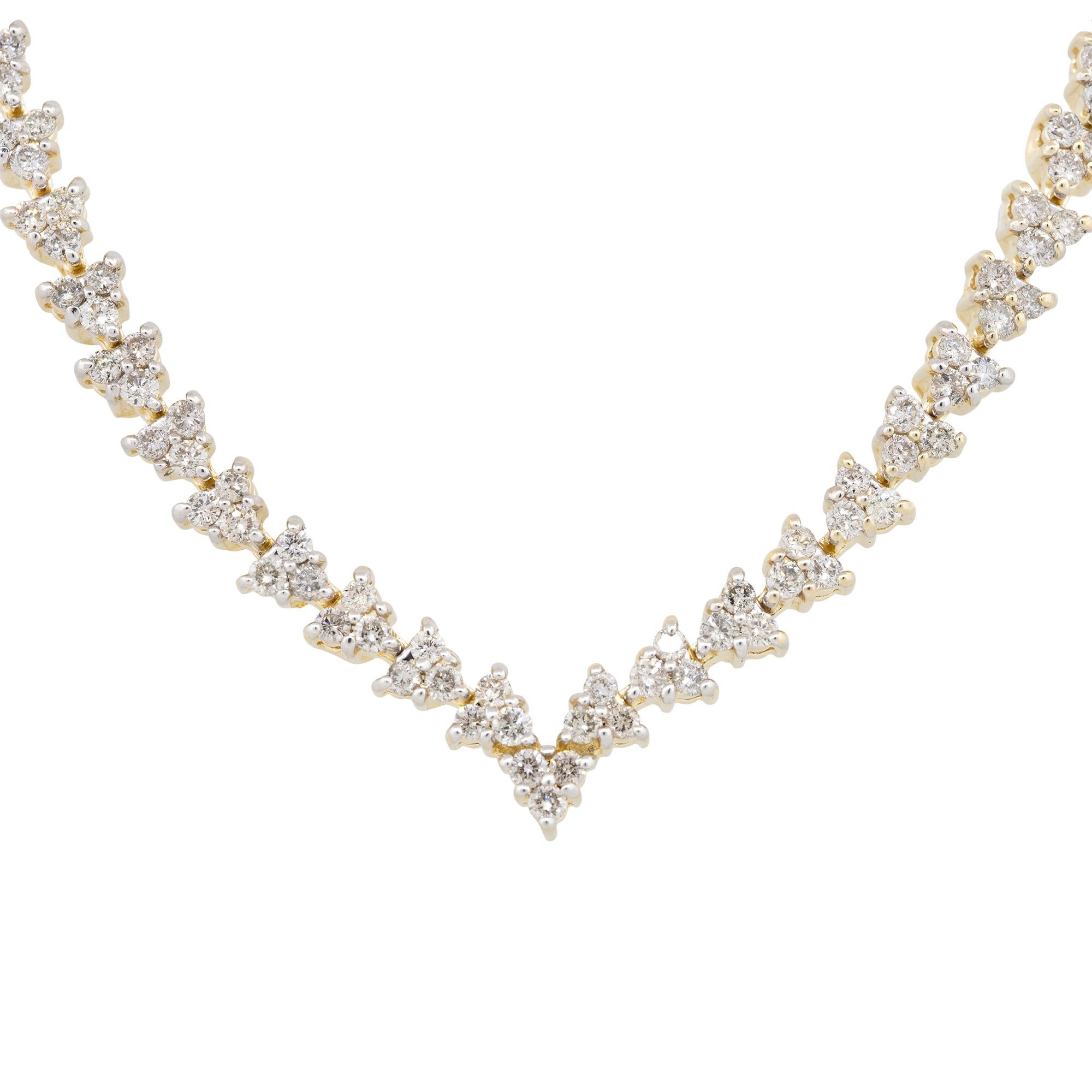This tennis necklace showcases 5.50 carats of round brilliant diamonds all set in 14 karat yellow gold. The diamonds are near colorless, approximately a H/I in color, and are approximately SI in clarity. This necklace is a staple item for any women