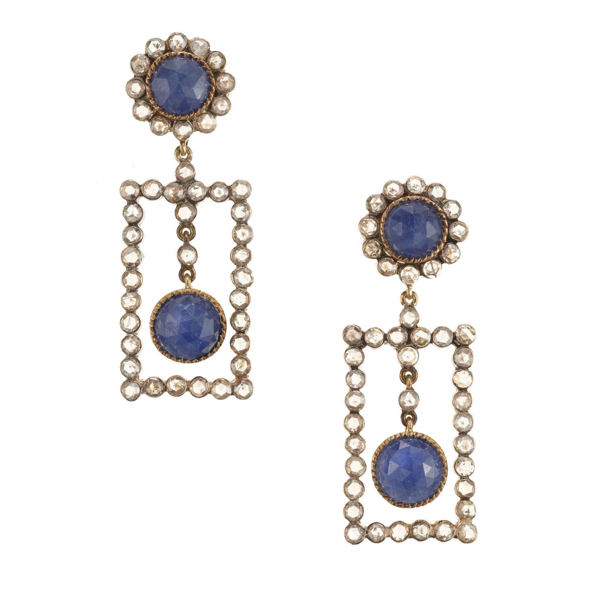 Boucles d'oreilles pendantes faites à la main en or jaune 18 carats avec des diamants classiques taillés en rose encadrant le haut et le bas et serties de 2 grands saphirs taillés en rose, un en haut et un en bas. Bon bleu moyen avec des inclusions