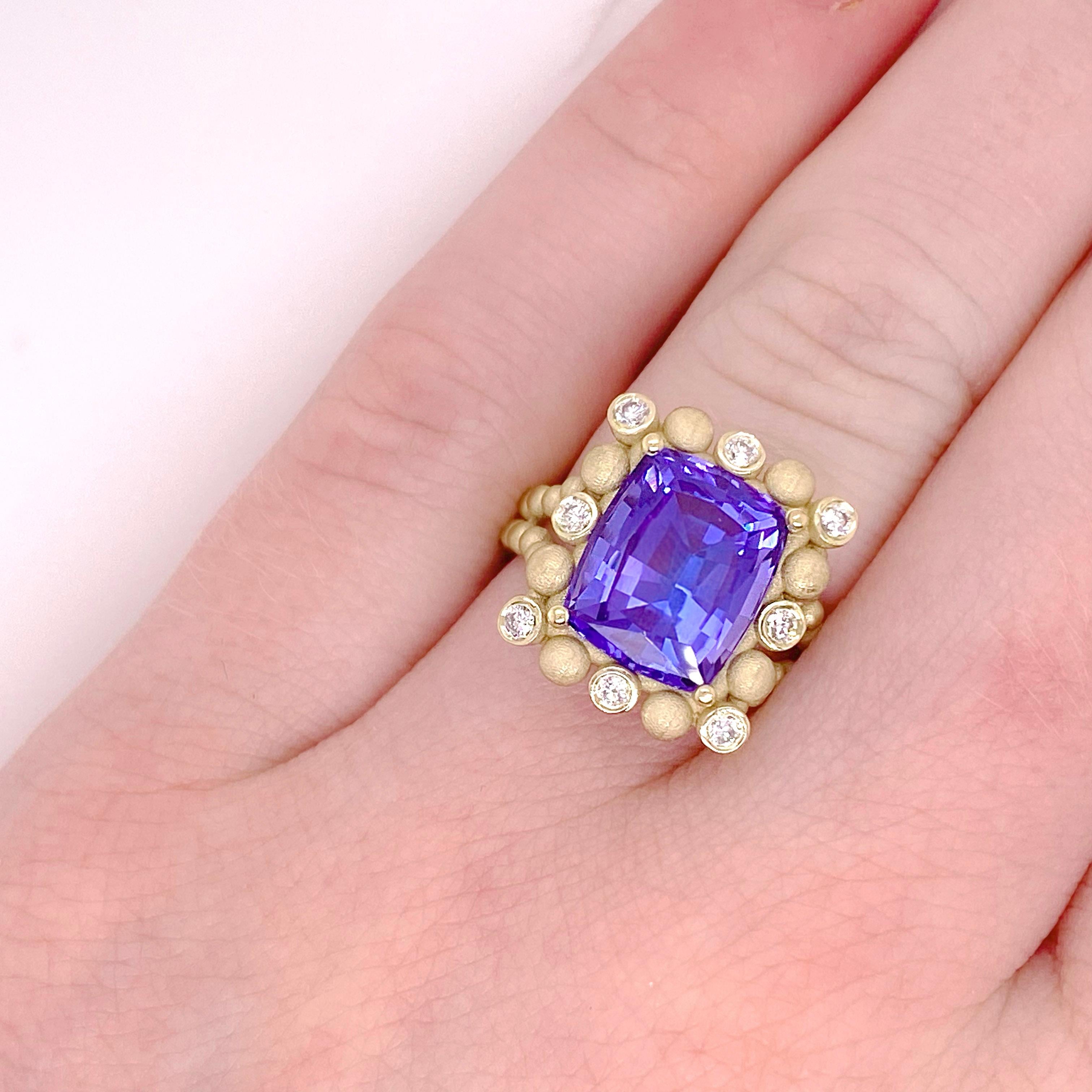 One-of-a-kind, custom made Tanzanite ring. This ring is an authentic Five Star Jewelry original design. The ring is made with 14 karat yellow gold and holds a genuine tanzanite gemstones that weighs over 5 carats!! Framing the center stone are
