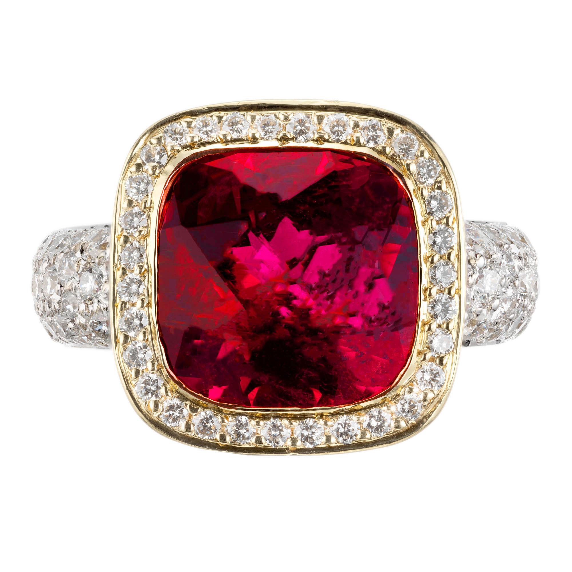 Bright red, pink tourmaline and diamond cocktail ring. 5.50 center cushion cut tourmaline with a halo of round diamonds in a 18k yellow and white gold setting with round diamonds along the shank. 

1 cushion cut reddish pink tourmaline SI (minor
