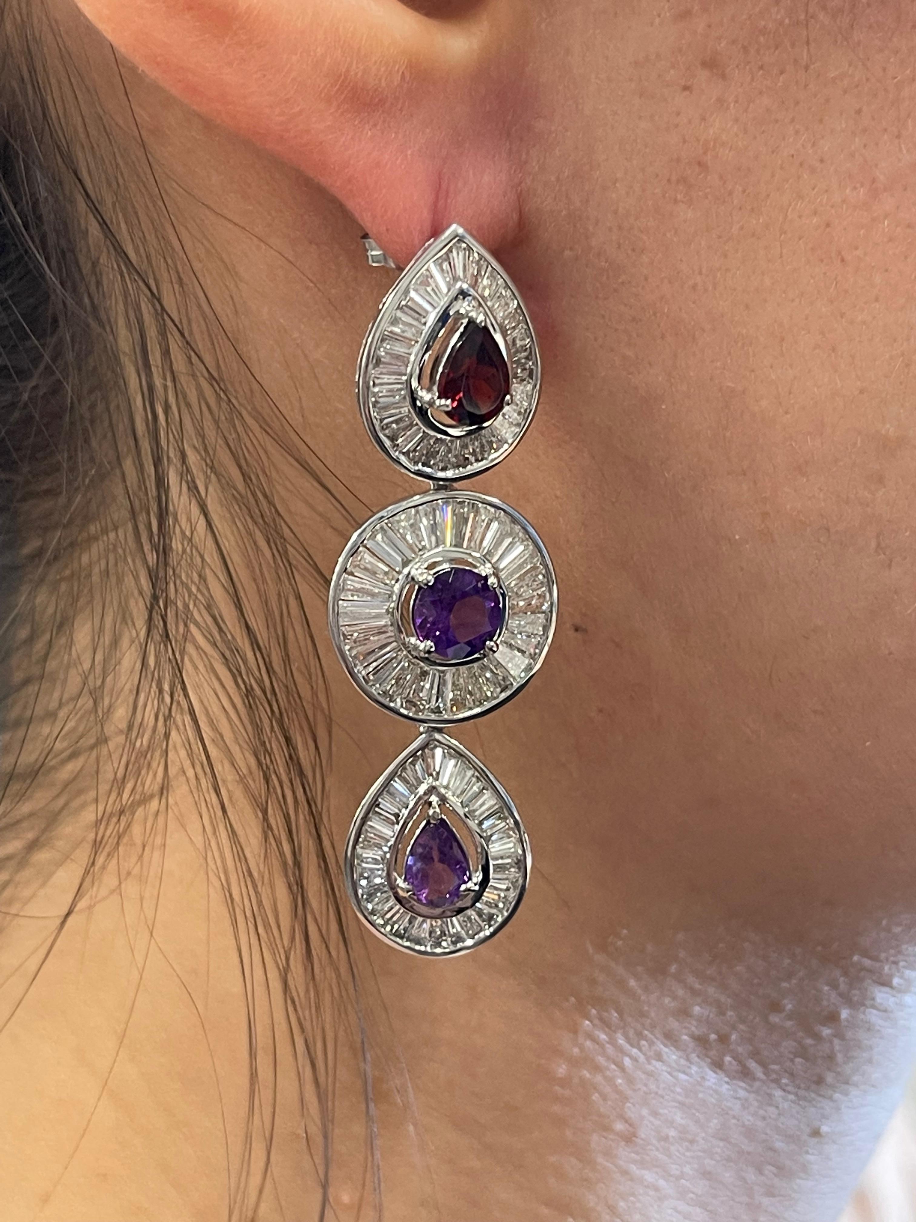 This pair of show-stopping linear Gemstone Sapphire dangle earrings are finely crafted in 18k white gold and showcase a stunning display of Sapphire artfully displayed in a decadent design. Mixed shaped colorful sapphires total 5.50 carats, these