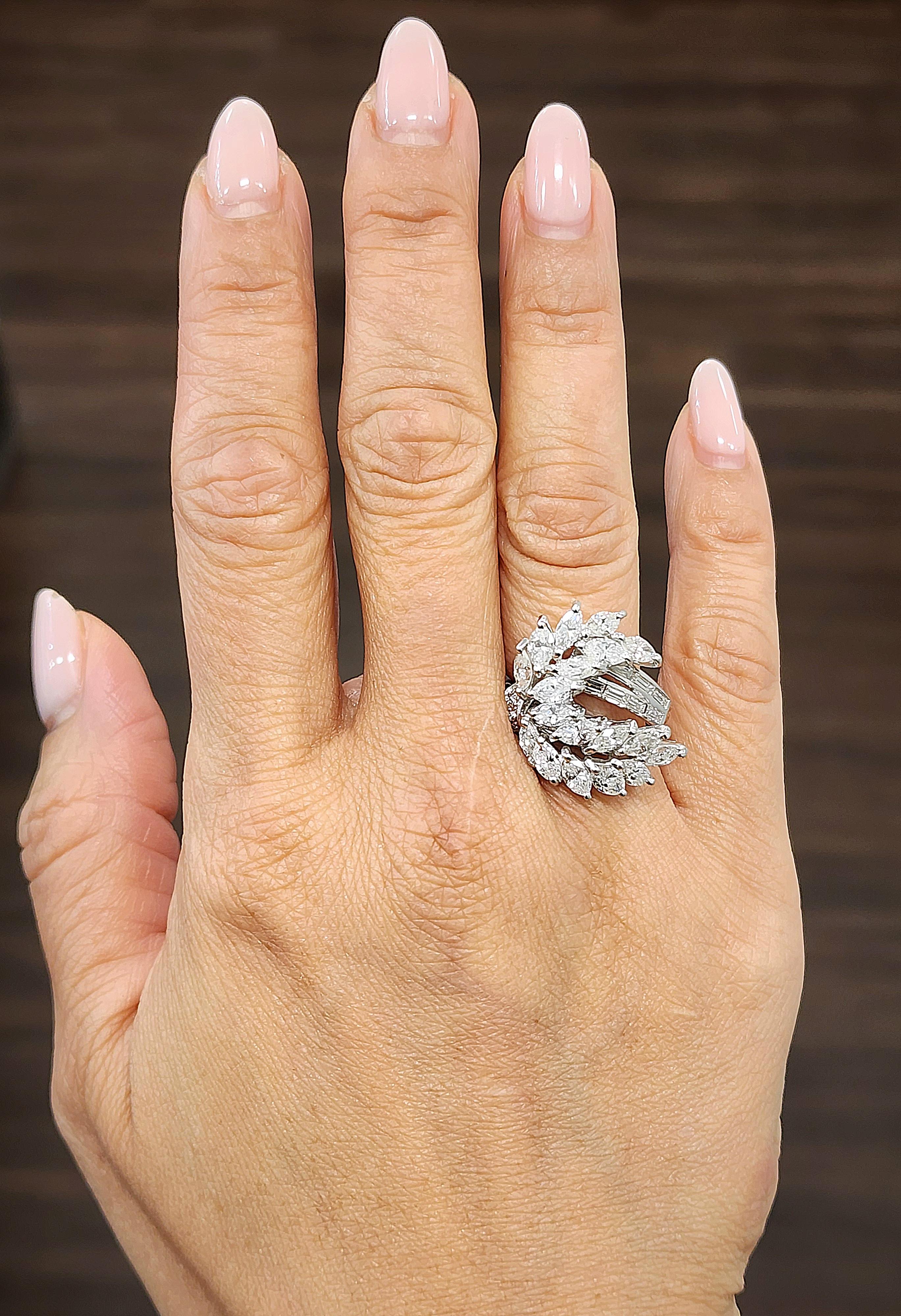 This gorgeous platinum ring weighs approximately 5.50 ct. The ring features marquis, rounds, and baguettes boasting F/G in color and VS1/VS2 in clarity. This is a magnificent ring to accompany any wardrobe.