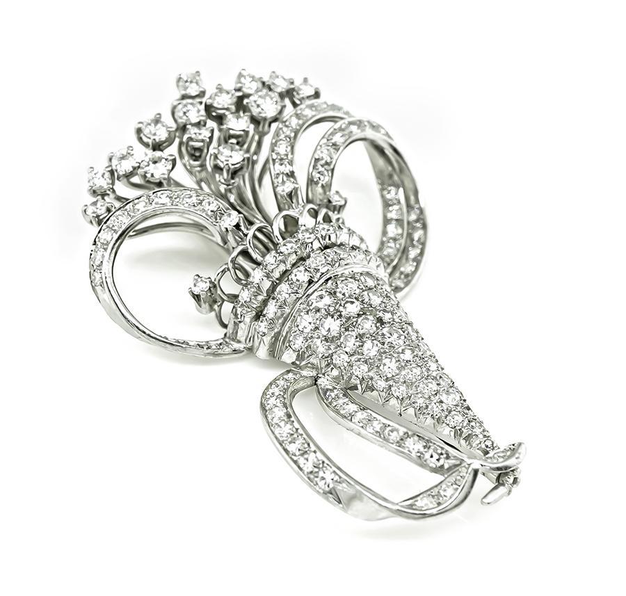 This is a magnificent platinum pin. The pin is set with sparkling round cut diamonds that weigh approximately 5.50ct. The color of these diamonds is F-G with VS clarity. The pin measures 52mm by 35.5mm and weighs 20.5 grams.