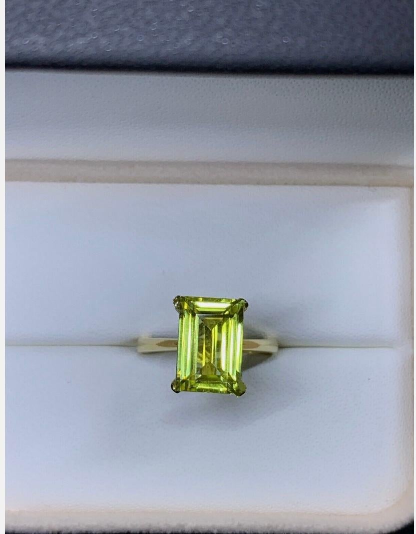5.50ct Yellow Sapphire Emerald Cut Solitaire Engagement Ring In 18ct Yellow Gold
This stunning engagement ring features a beautiful 5.50ct emerald cut yellow sapphire man made set in an 18ct yellow gold solitaire setting. The ring is designed in a