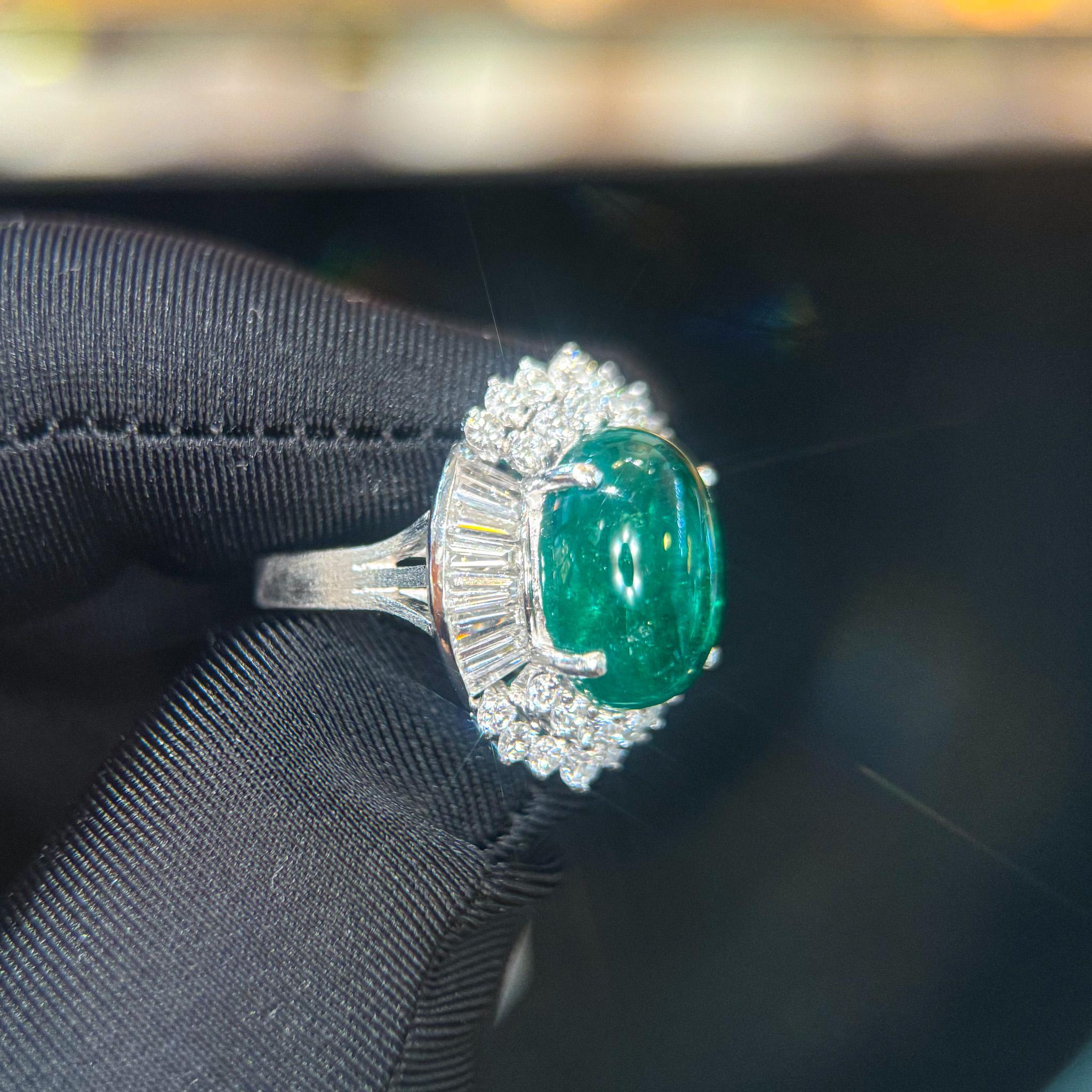 This striking ballerina statement ring features a 5.51 carat emerald cabochon surrounded by 1.83 carats of diamonds in a platinum setting. A bold design with a split shank and tiered accents, made to stand out. Ring size 5, adjustable. Vintage,