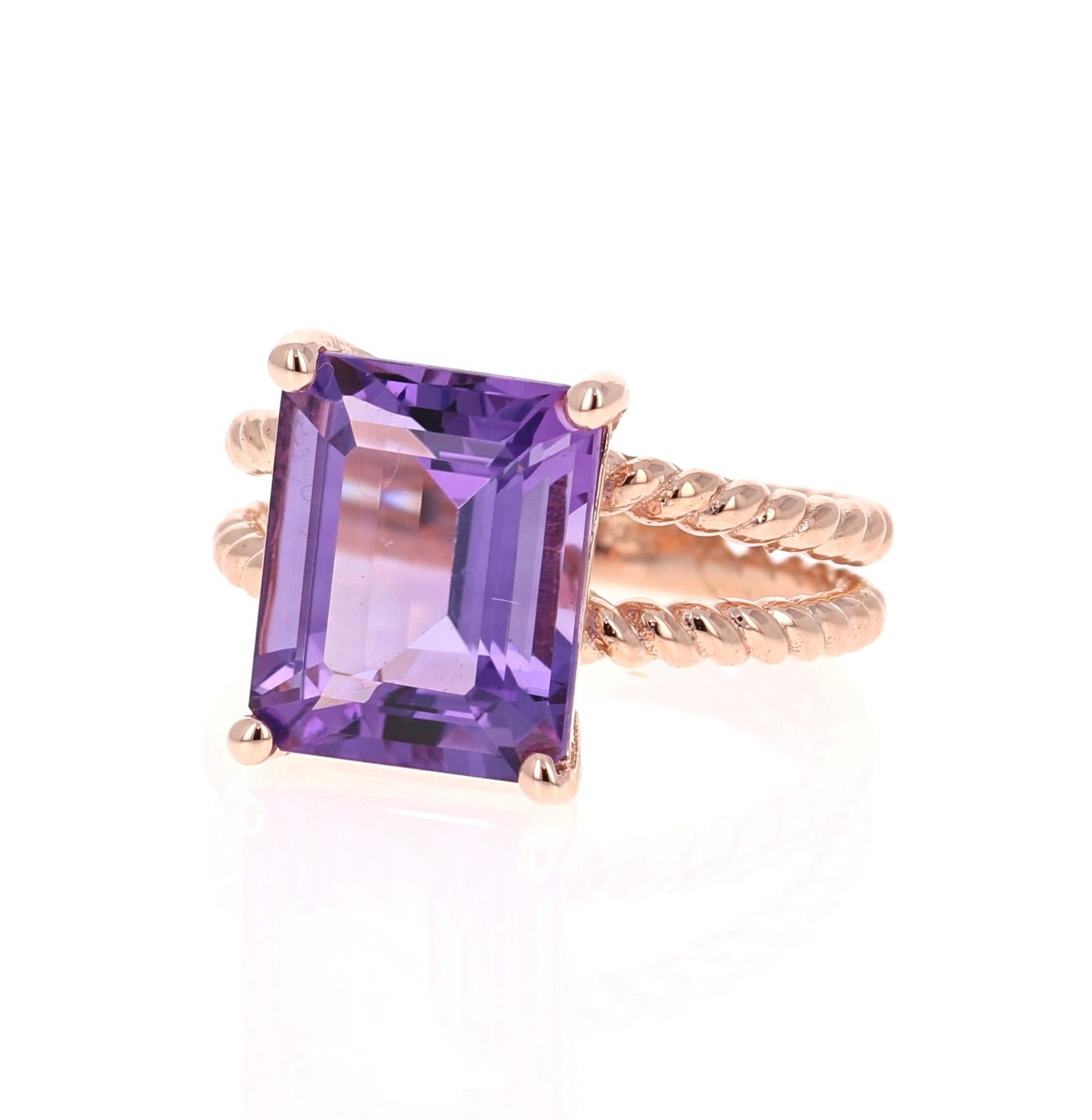 This Designer inspired ring has a bright and vivid Emerald Cut Amethyst in the center that weighs 5.51 carats. 
The setting is beautifully crafted in 14K Rose Gold and weighs approximately 5.1 grams.
The ring is a size 7 and can be re-sized if