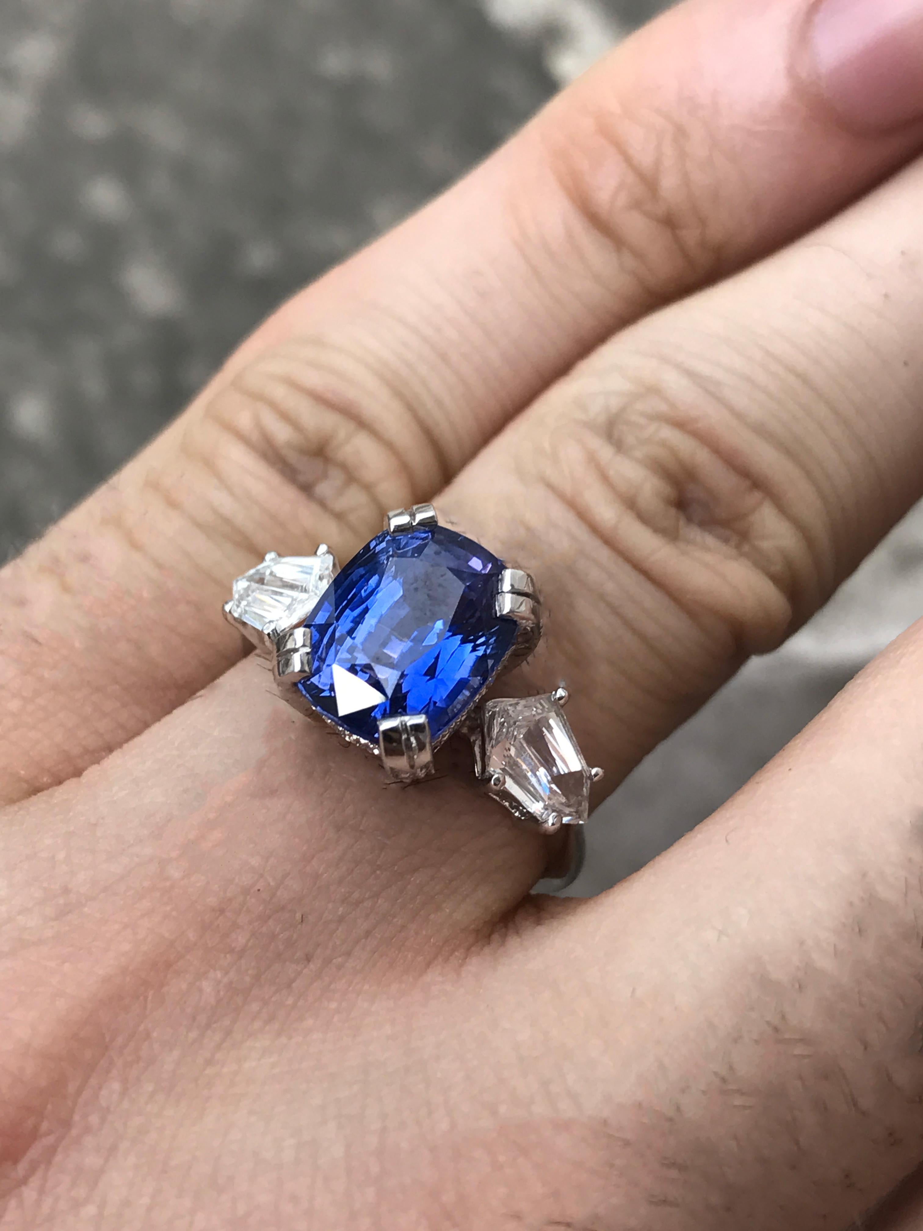 B8072003

5.52 Carat Blue Ceylon Sapphire , set in platinum. 2 Side Bullet Cut Diamonds weighing a total of 1.10 Carats G-H , VS

1. Carat Weight: 5.52 Sapphire

2. Color: Vivid Blue

3. Tone:  Medium - 7.5 Out of 10 (Best tone, not too light and