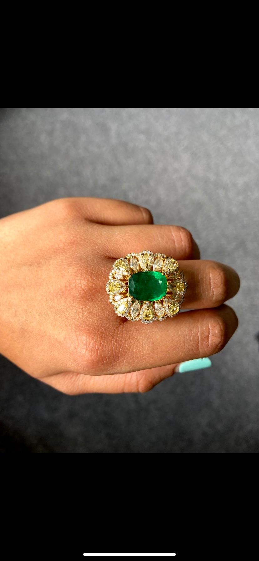 A stunning 5.52 carat cushion shape Zambian Emerald, with pear and marquise shape Yellow Diamonds cocktail ring. All set in solid 18K Yellow Gold. Currently the ring is sized at US 6, but can be altered. 
Free shipping provided, and we accept