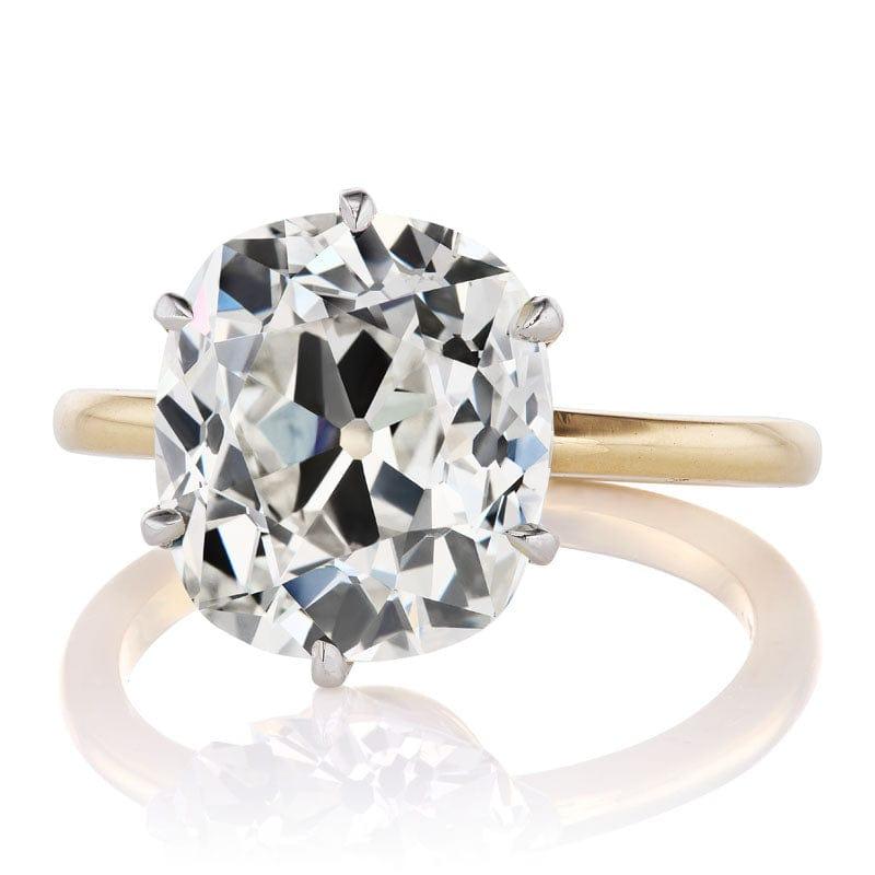 This ring is a VB original design made right here in NYC using an authentic antique diamond. The ring centers a GIA-certified 5.52-carat old mine cut diamond of L color, VS2 clarity. The stone is set in a 6 prong platinum basket on an 18kt yellow