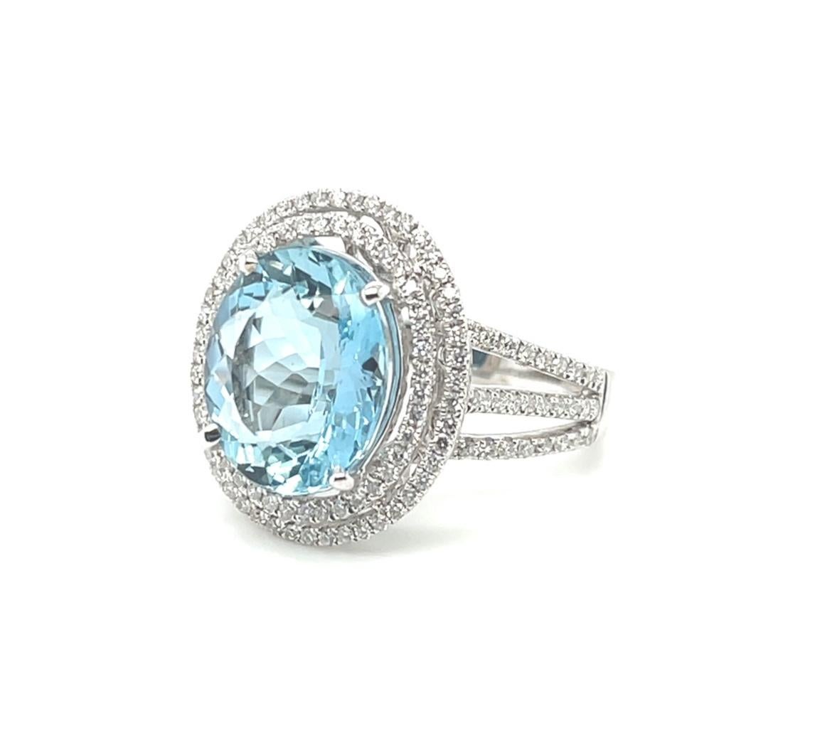 This striking aquamarine and diamond halo cocktail ring will make a gorgeous addition to your fine jewelry collection! A beautiful 5.52 carat oval aquamarine with beautiful color and brilliance is prong set in 18 white gold, surrounded by a double