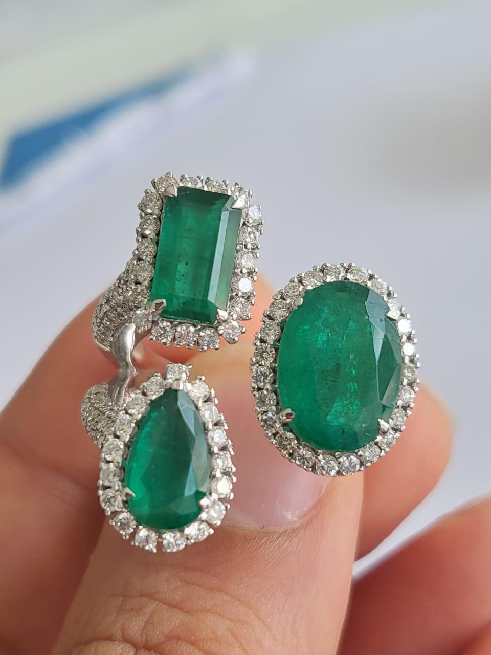 A very beautiful and one of a kind, Emerald Three Stone Cocktail Ring set in 18K White Gold & Diamonds. The weight of the Emeralds is 15.52 carats. The Emeralds are completely natural, without any treatment and are of Zambian origin. The weight of