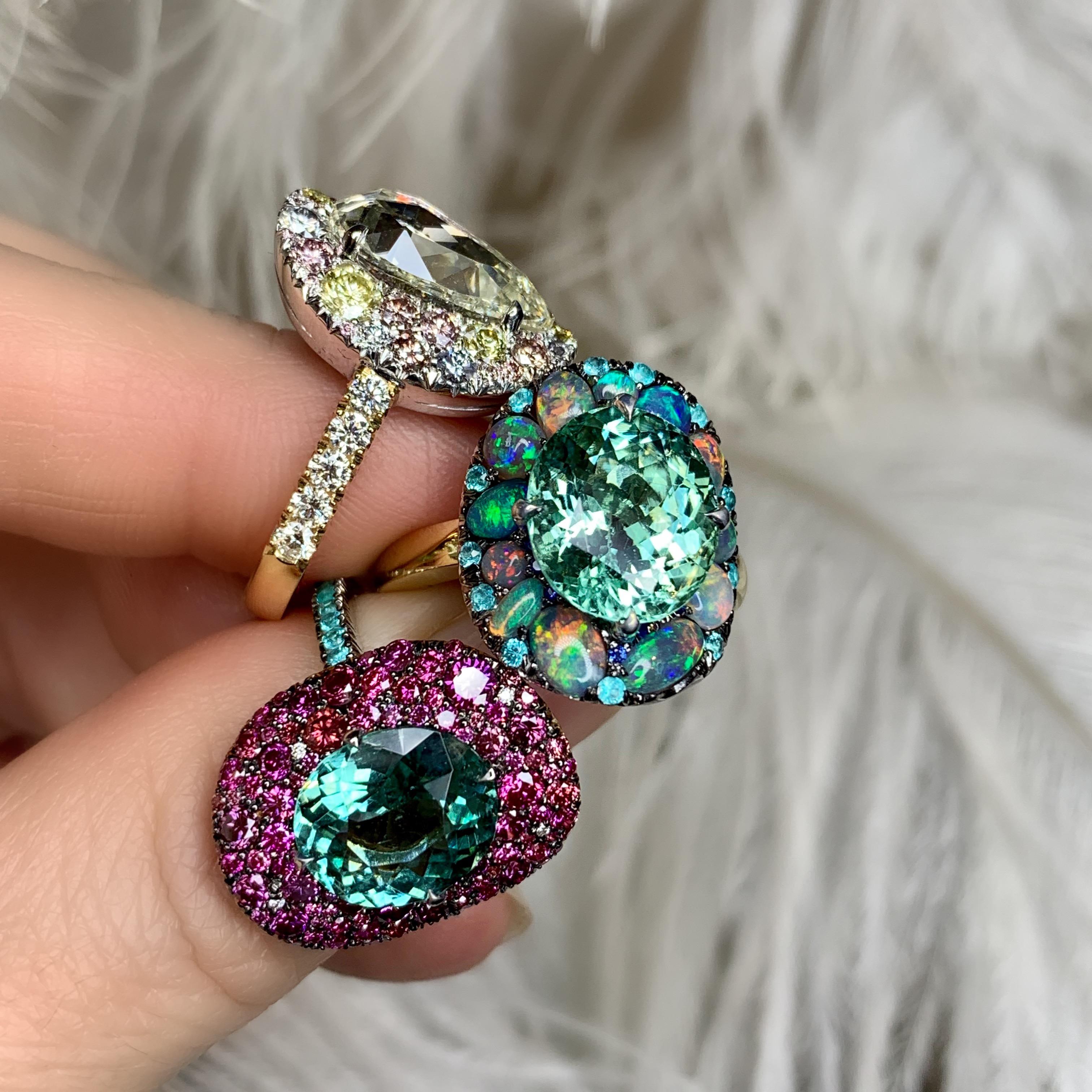 One of a kind ring in 18K yellow & White gold 16,5 g. set with a Lagoon Tourmaline centerstone 5,52 ct., Black Opal cabochons 1,67 ct., Paraïba Tourmaline 0,3 ct. and royal blue sapphires 0,055 ct.  Handmade the traditional way, ajour on the inside.