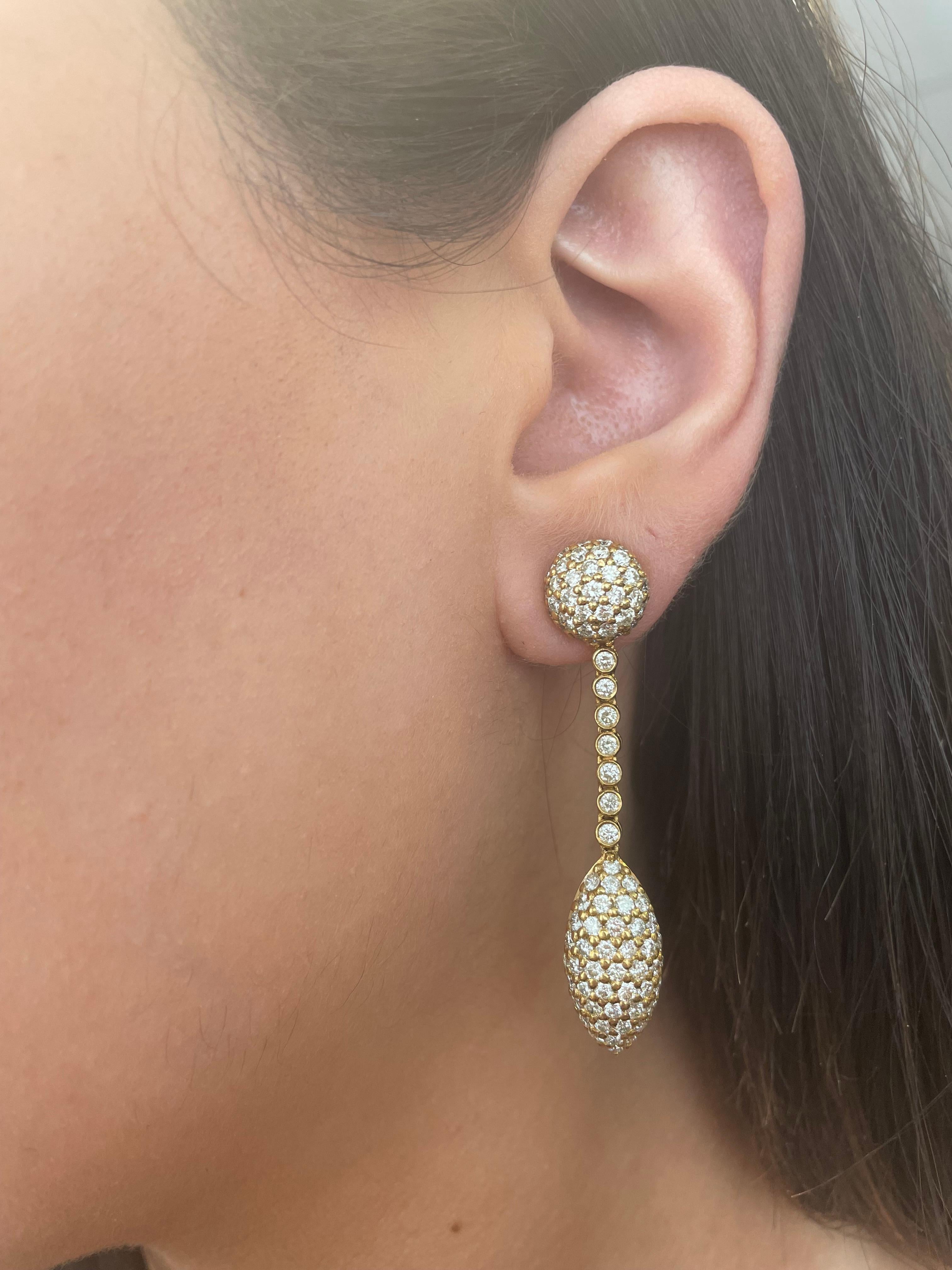 Stunning pave diamond drop earrings.
Round brilliant diamonds, 5.52 carats total. Approximately G/H color grade and SI clarity grade. Pave and bezel set, 18k yellow gold.
3.32ct total diamond weight. 
Accommodated with an up to date appraisal by a