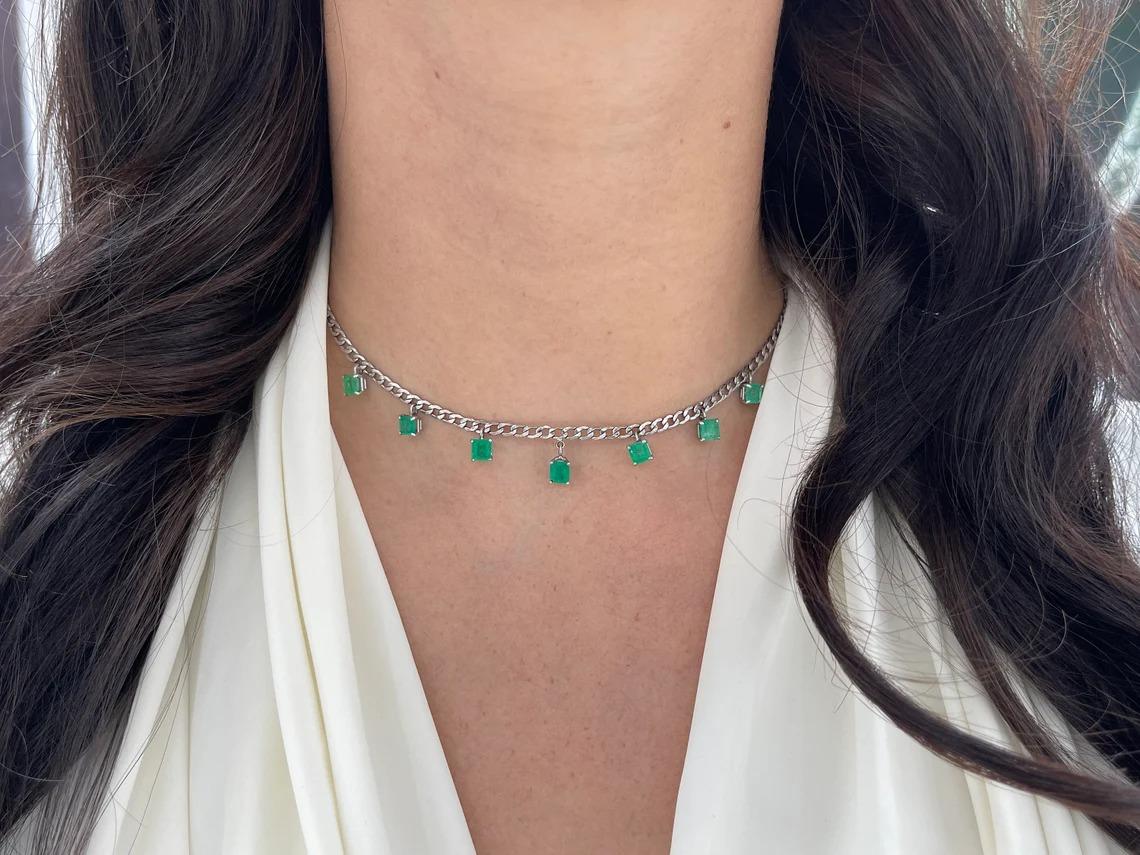 A remarkable emerald fringe necklace crafted to perfection. This piece features seven, stunning natural emeralds from the origin of Colombia; which showcase a desirable medium green color, with very good clarity and luster. Skillfully prong set on a