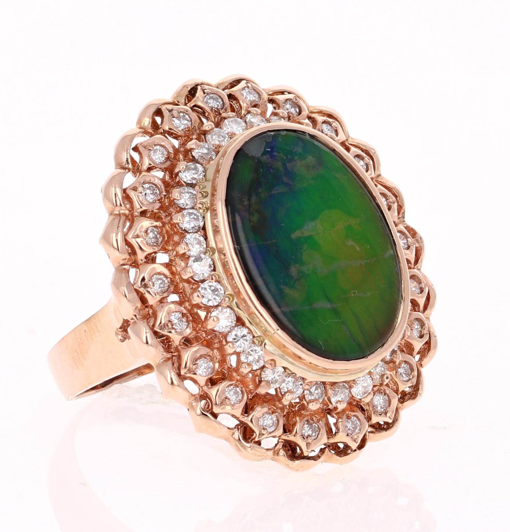 This unique ring has a 4.76 Carat Oval Cut Ammolite in the center of the ring.  Ammolite is an Opal-like organic gemstone that is primarily found in the eastern slopes of the North American Rocky Mountains. The Ammolite has hues of green and blue