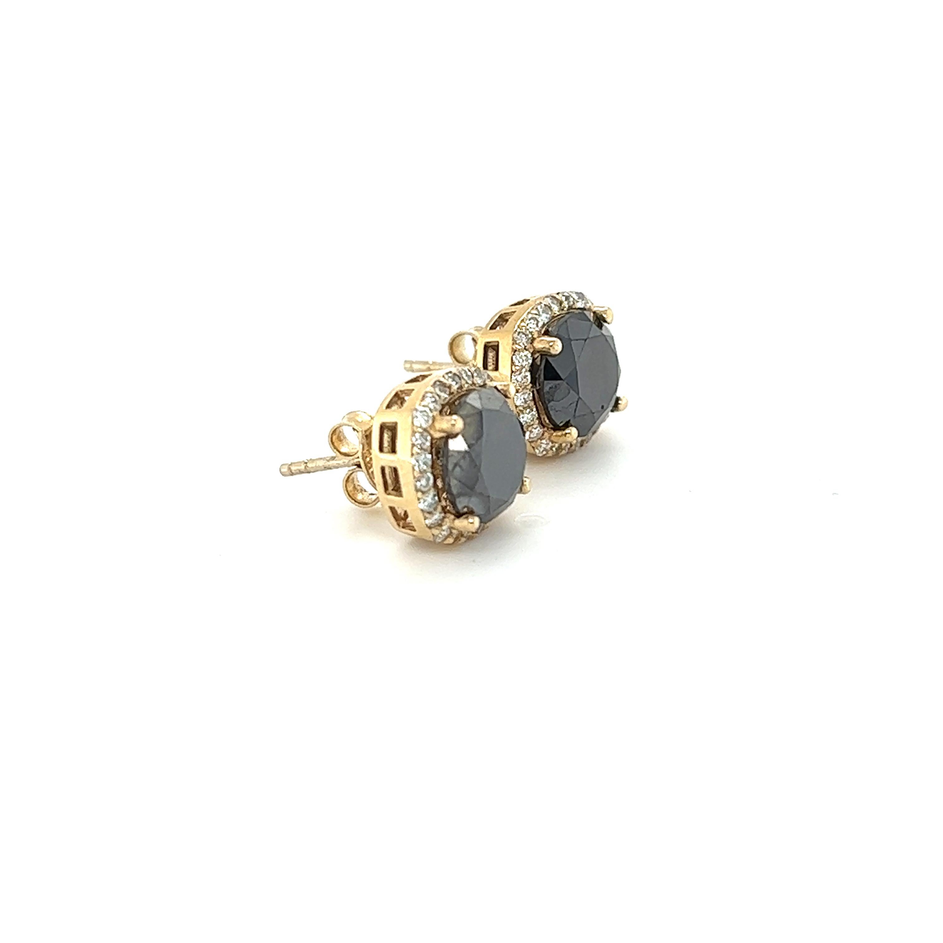 These stud earrings have Natural Black Round Cut Diamonds that weigh 5.04 Carats and have Natural Round Cut Diamonds that weigh 0.50 Carats. (Clarity: VS, Color: H) The total carat weight of the earrings are 5.54 Carats. The black diamonds measure