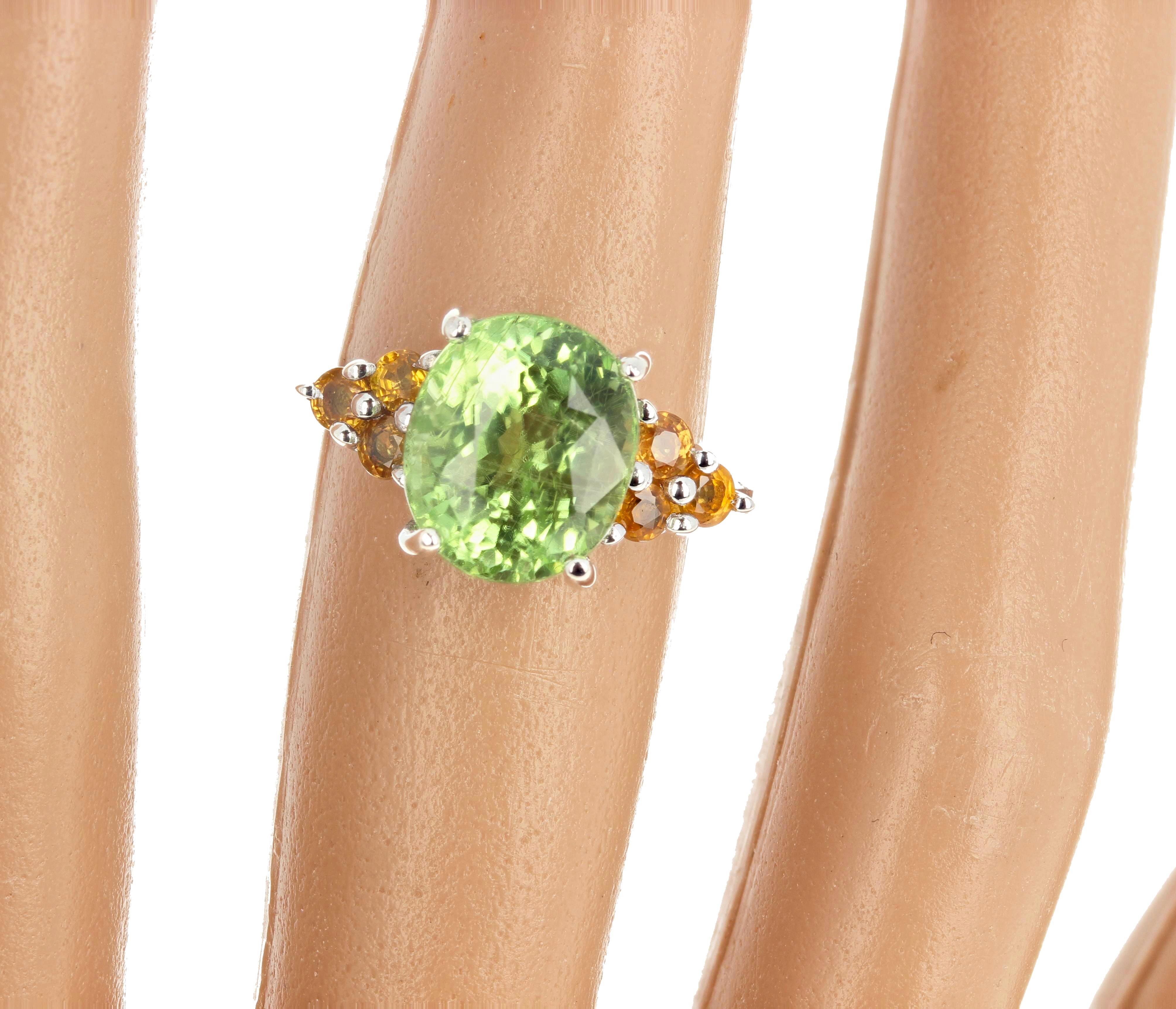 Glittering 5.54 carat natural green Tourmaline (11 mm x 9 mm) enhanced with sparkling little bright yellow Citrines set in a sterling silver ring size 7 1/4 (sizable for free).  There are NO eye visible inclusions in the Tourmaliine.  This gorgeous