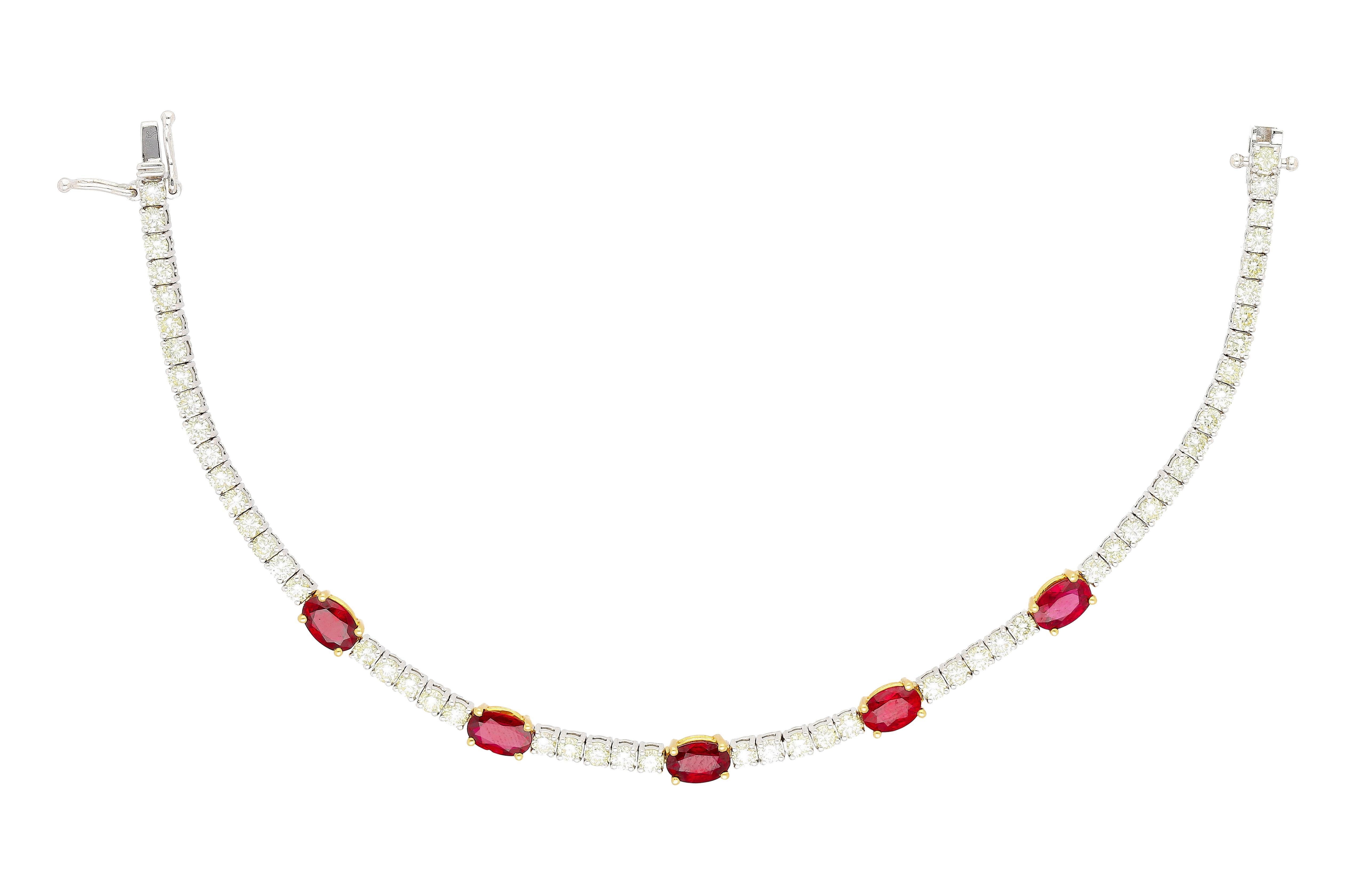 Natural Ruby and  Diamond Tennis Bracelet in Two Tone Gold. 

This two tone gold tennis bracelet, is crafted from both 18k yellow and white gold. It features 5 oval-cut natural red ruby stones, weighing 2.91 carats total. The rubies are paired with