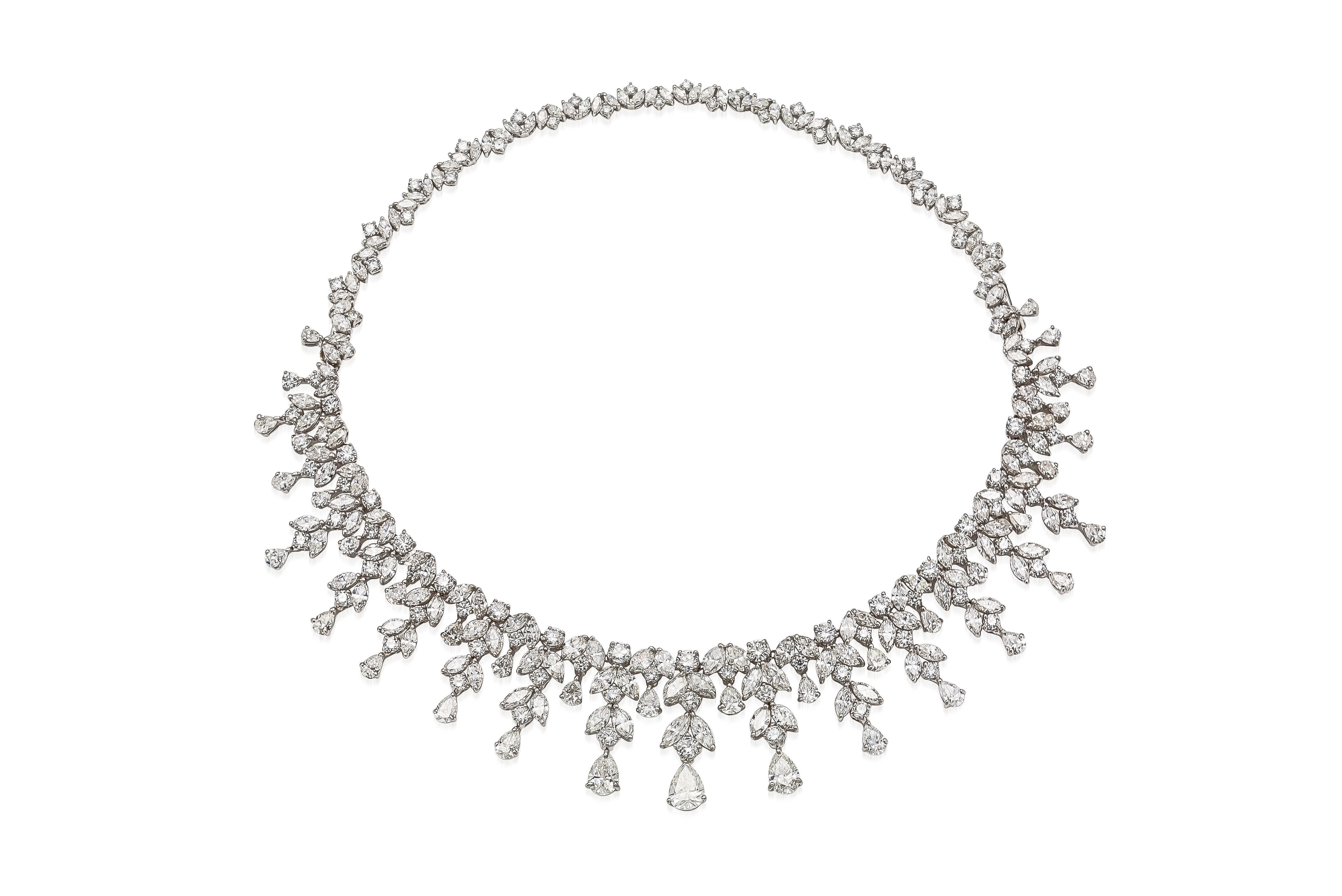 Finely crafted in platinum with Pear-Shaped, Marquise, and Round Brilliant cut Diamonds weighing a total of 55.44 carats.
The center 3 Pear-Shaped Diamonds are GIA certified;
1.65 carat, G color, VS1 clarity, GIA #1176054241
1.22 carat, G color, VS1