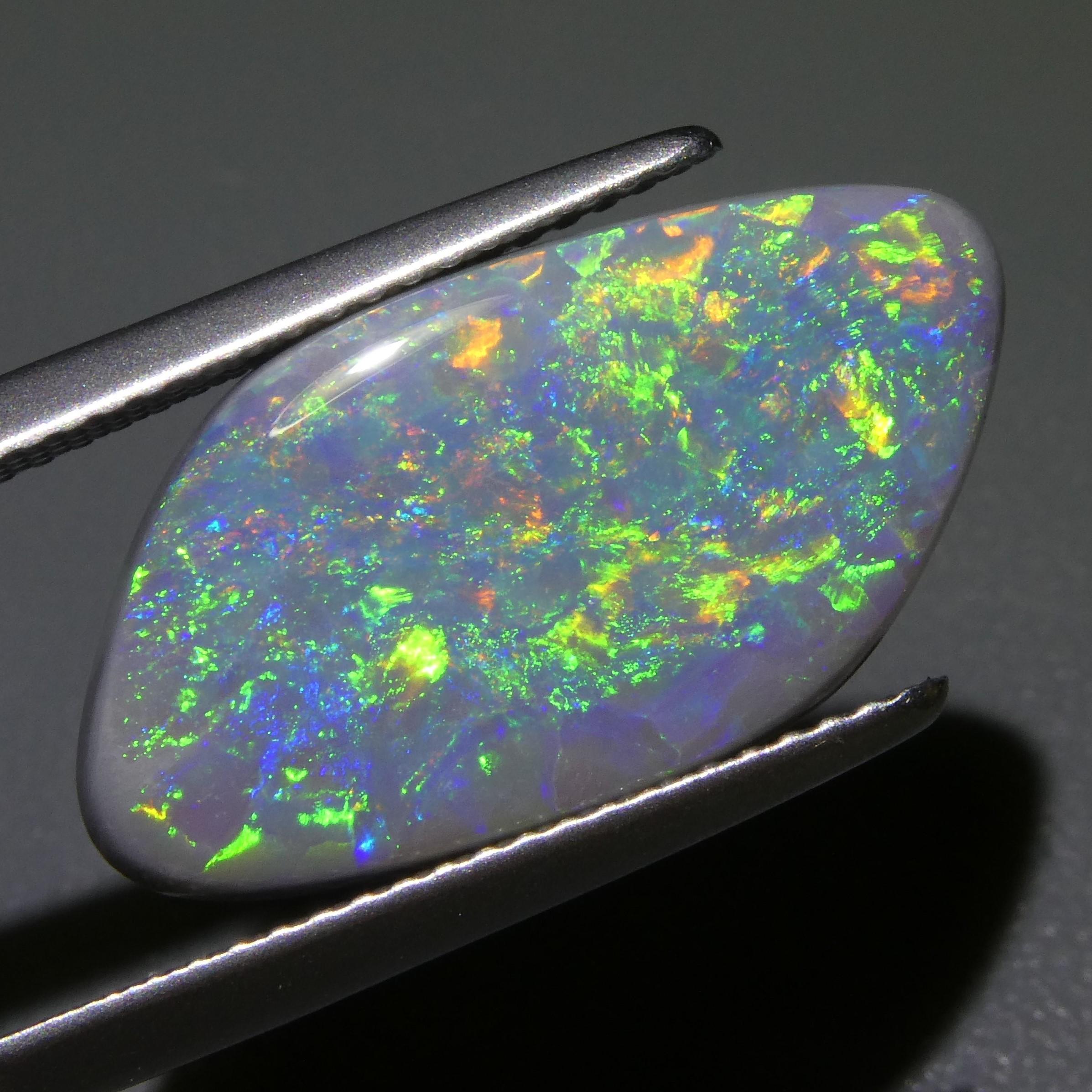 This is a stunning GIA Certified Opal 

The GIA report reads as follows:

GIA Report Number: 2211817189
Shape: Freeform Tablet
Cutting Style: 
Cutting Style: Crown: 
Cutting Style: Pavilion: 
Transparency: Translucent
Color: Gray
Phenomenon: