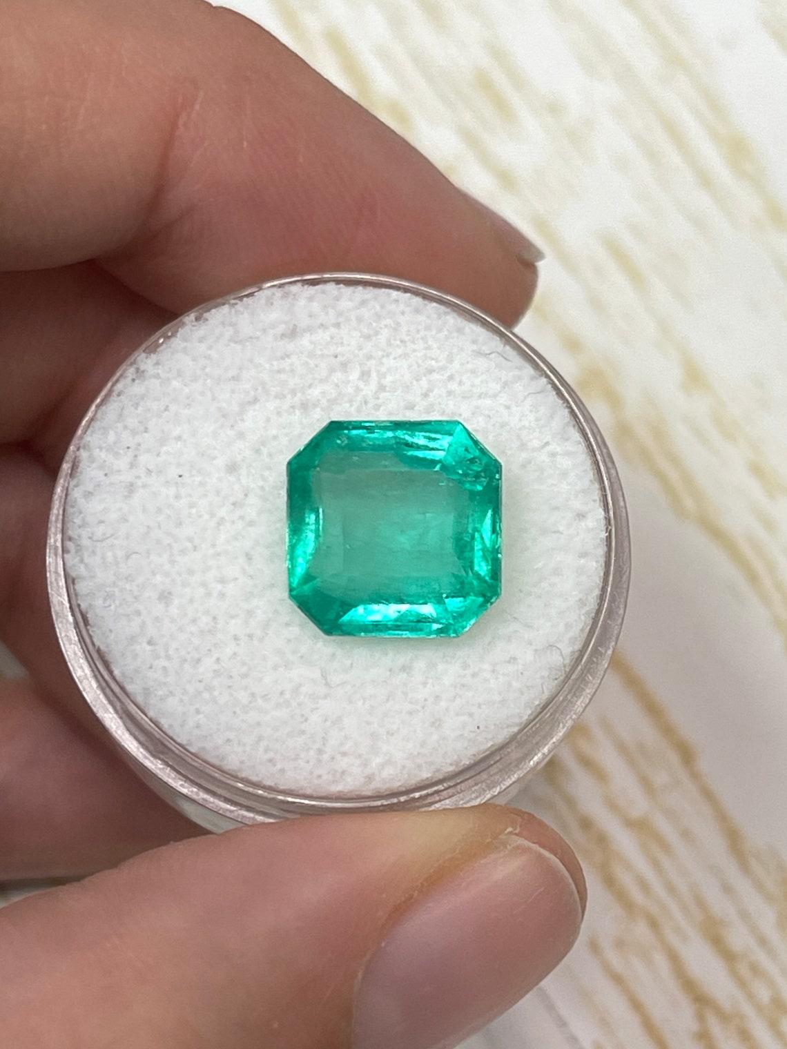 Stone: Emerald
Weight: 5.55-carats
Shape: Asscher Cut
Clarity: Transparent
Luster: Very Good
Color: Bluish Green
Measurements: 10.75mm x 10.89mm x 6.75mm
Geographic Origin: Colombia
Treatment: Natural, Oiling

Comments: Due to their growth